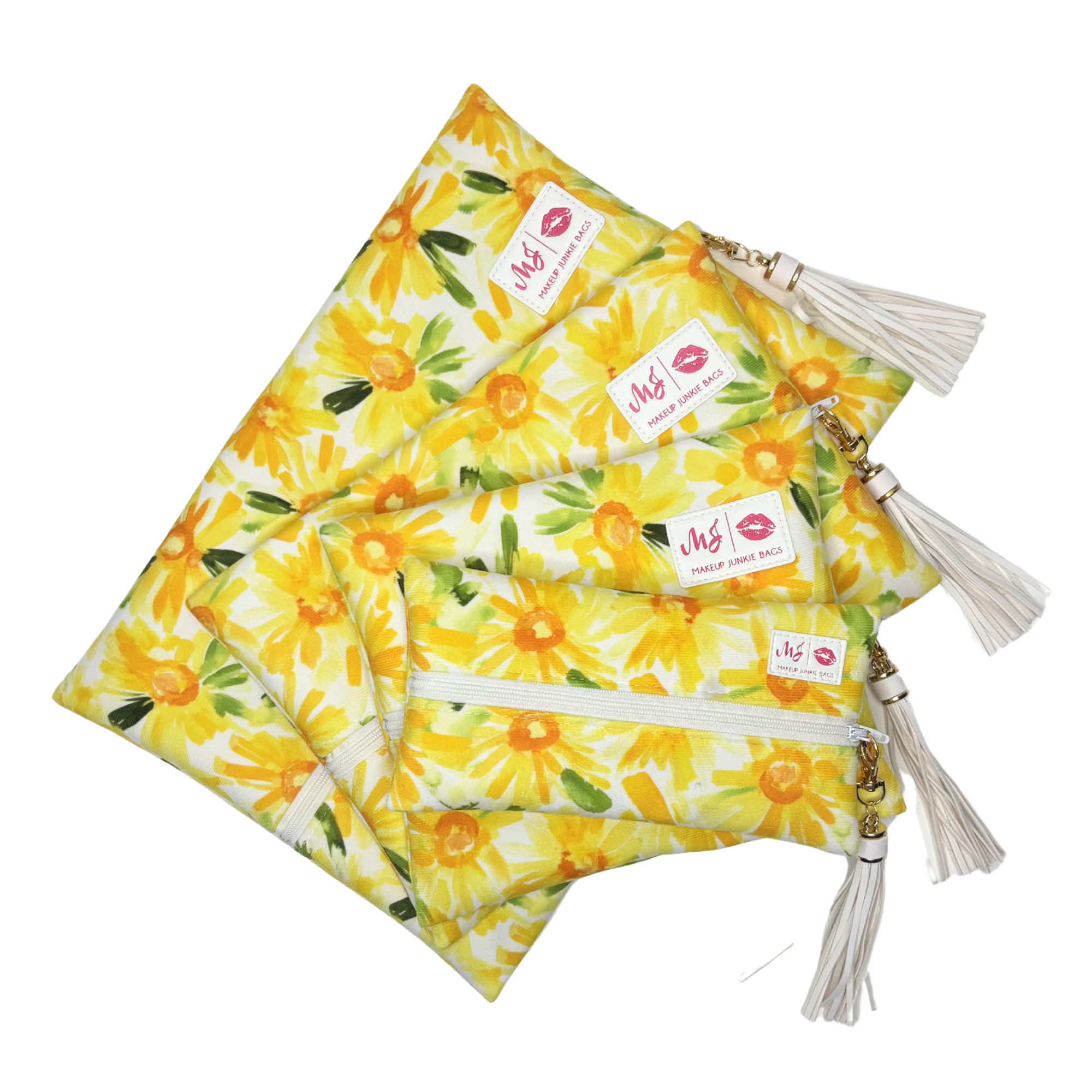 Set of yellow floral pouches with tassels on a white background