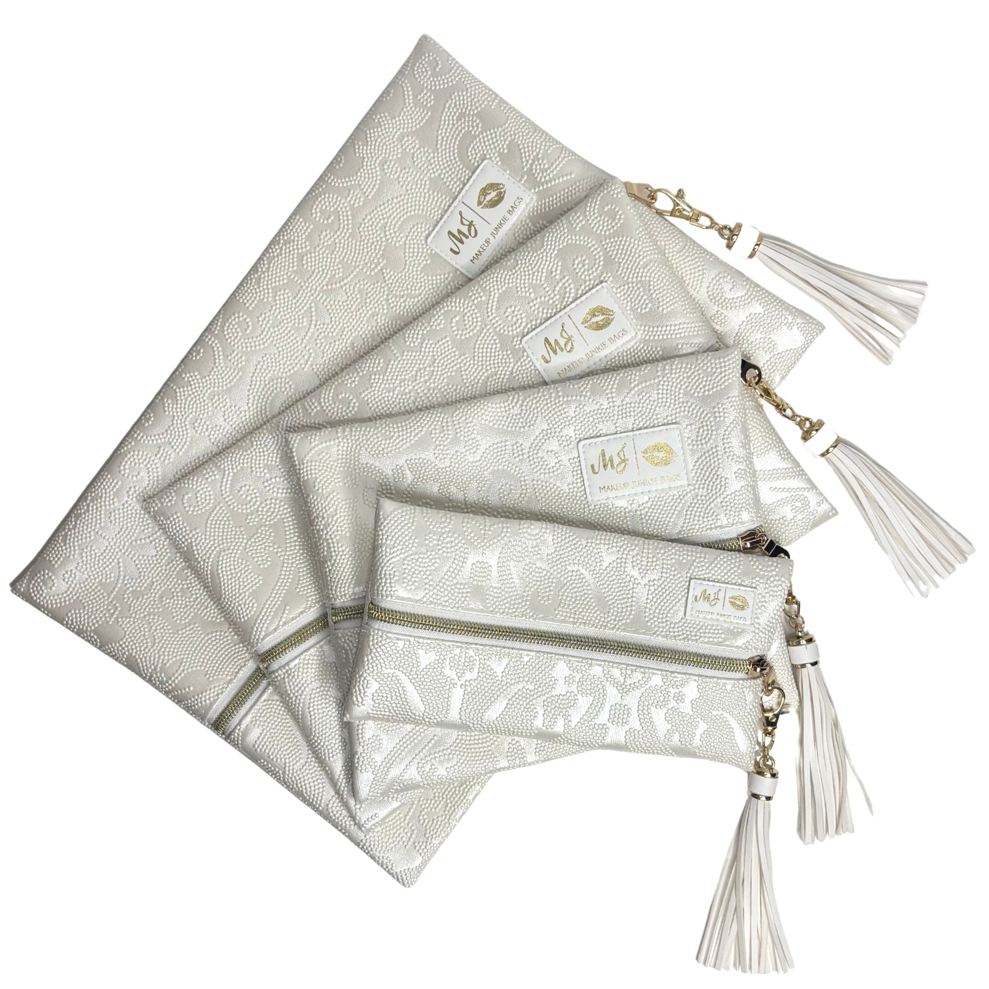 Set of silver pouches with tassels on a white background