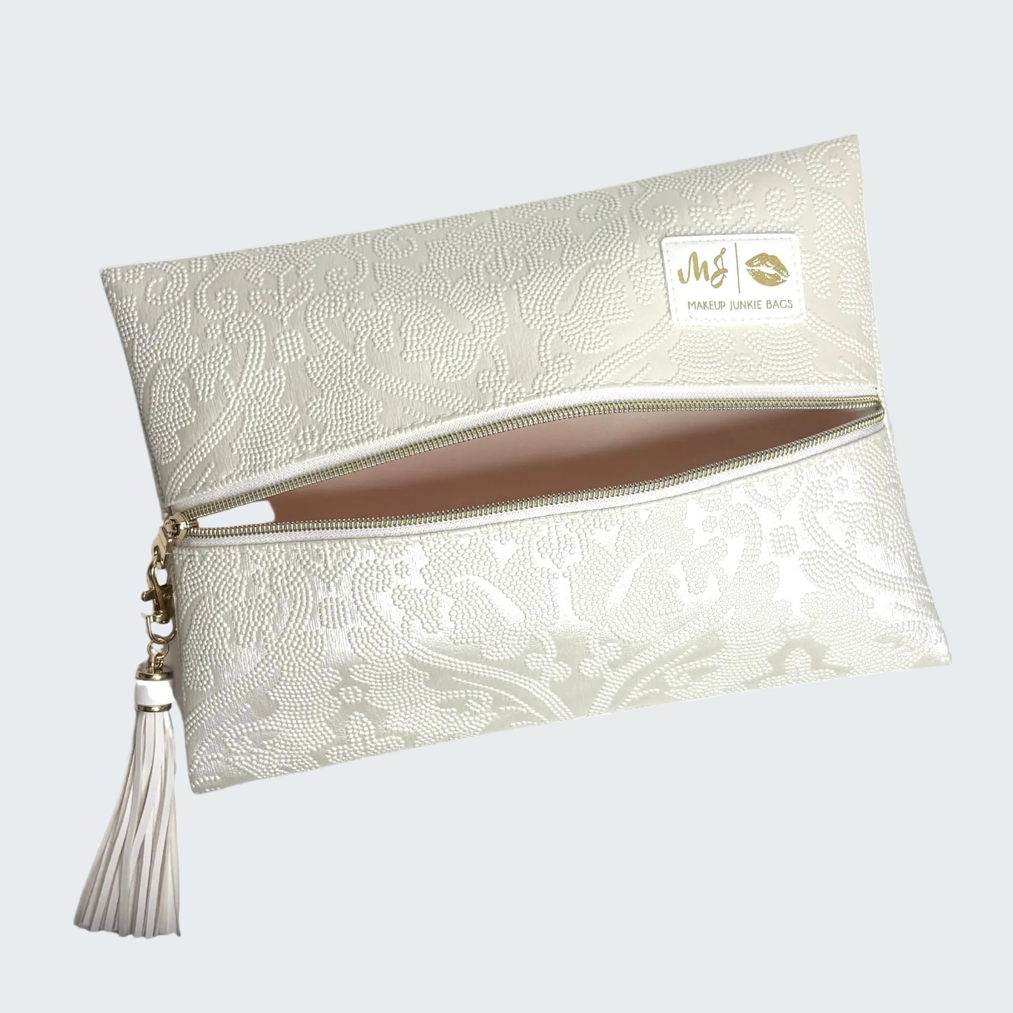 White lace clutch bag with a tassel on a white background