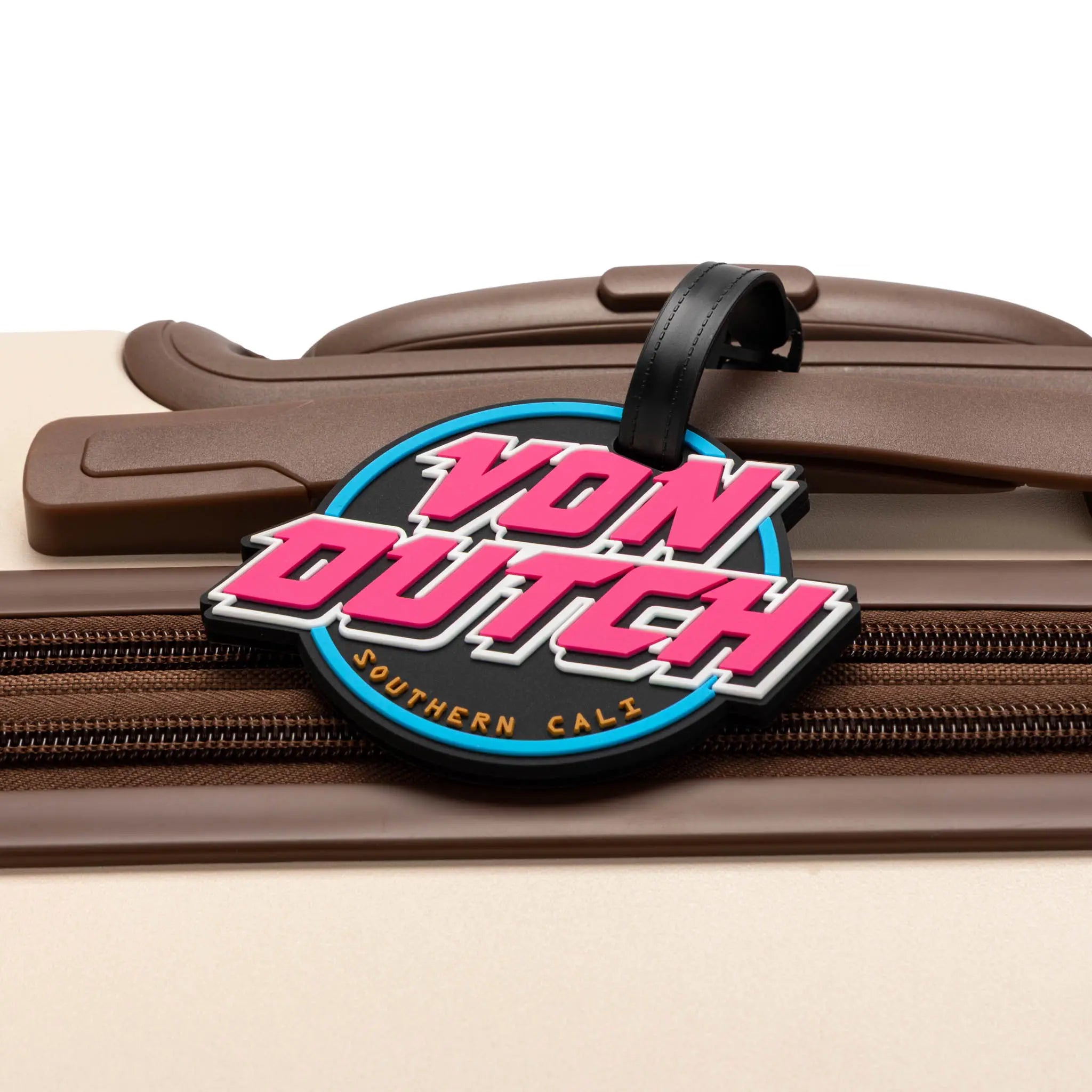Von Dutch luggage tag on a suitcase with a white background
