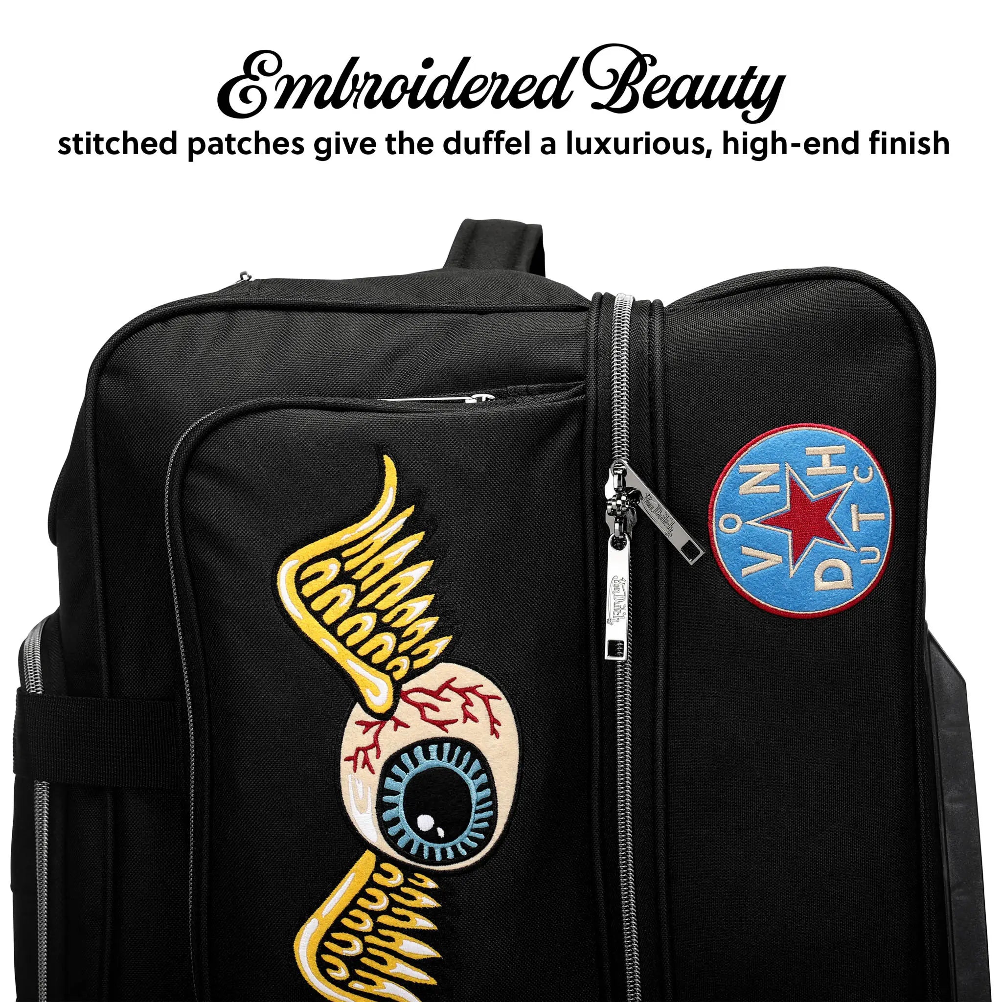 Black duffel bag with embroidered designs and patches on a white background