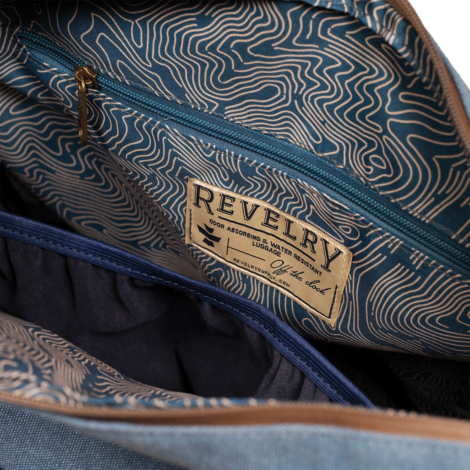 Close-up of a blue patterned bag with 'Revelry' branding.