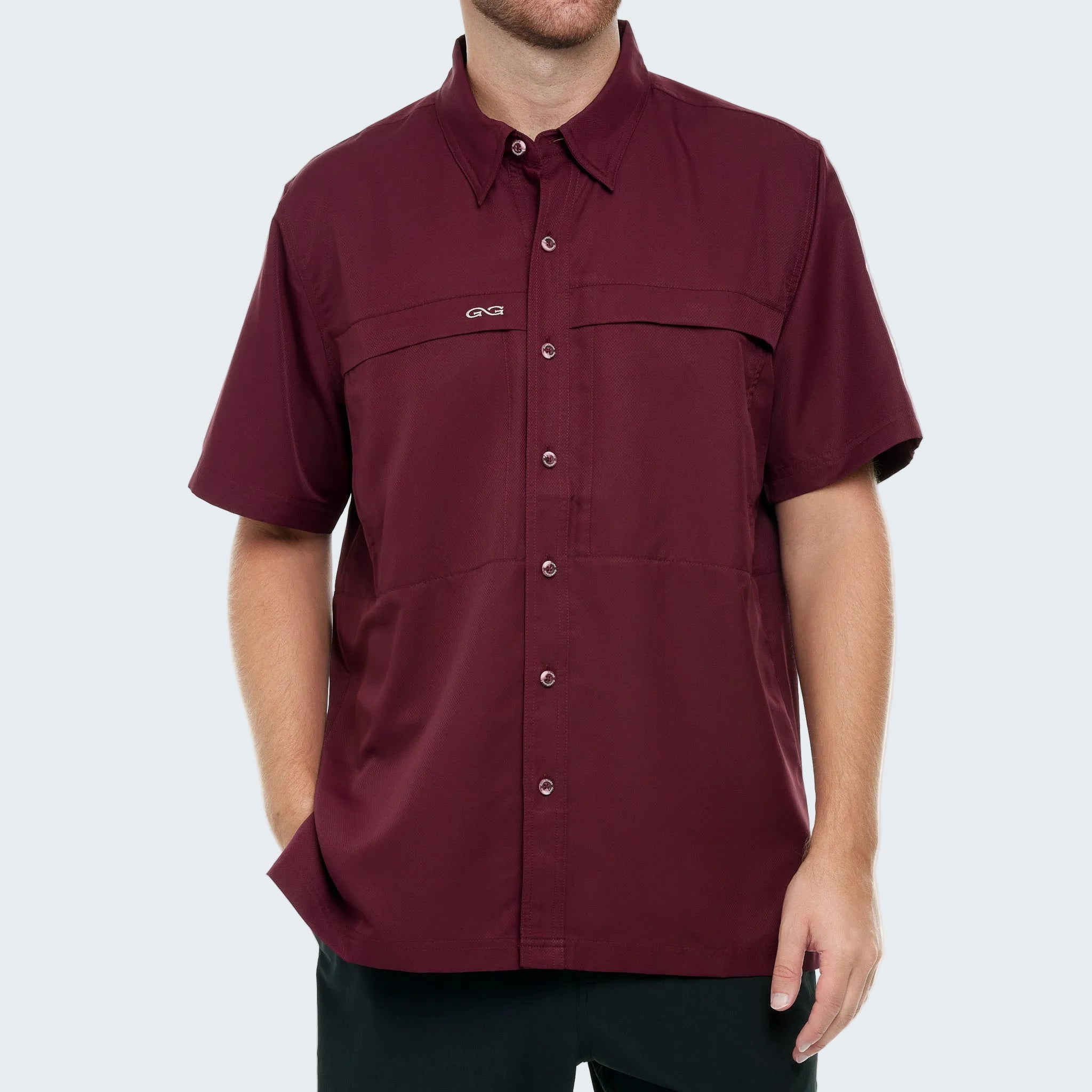 Maroon short-sleeve shirt with button details on a white background