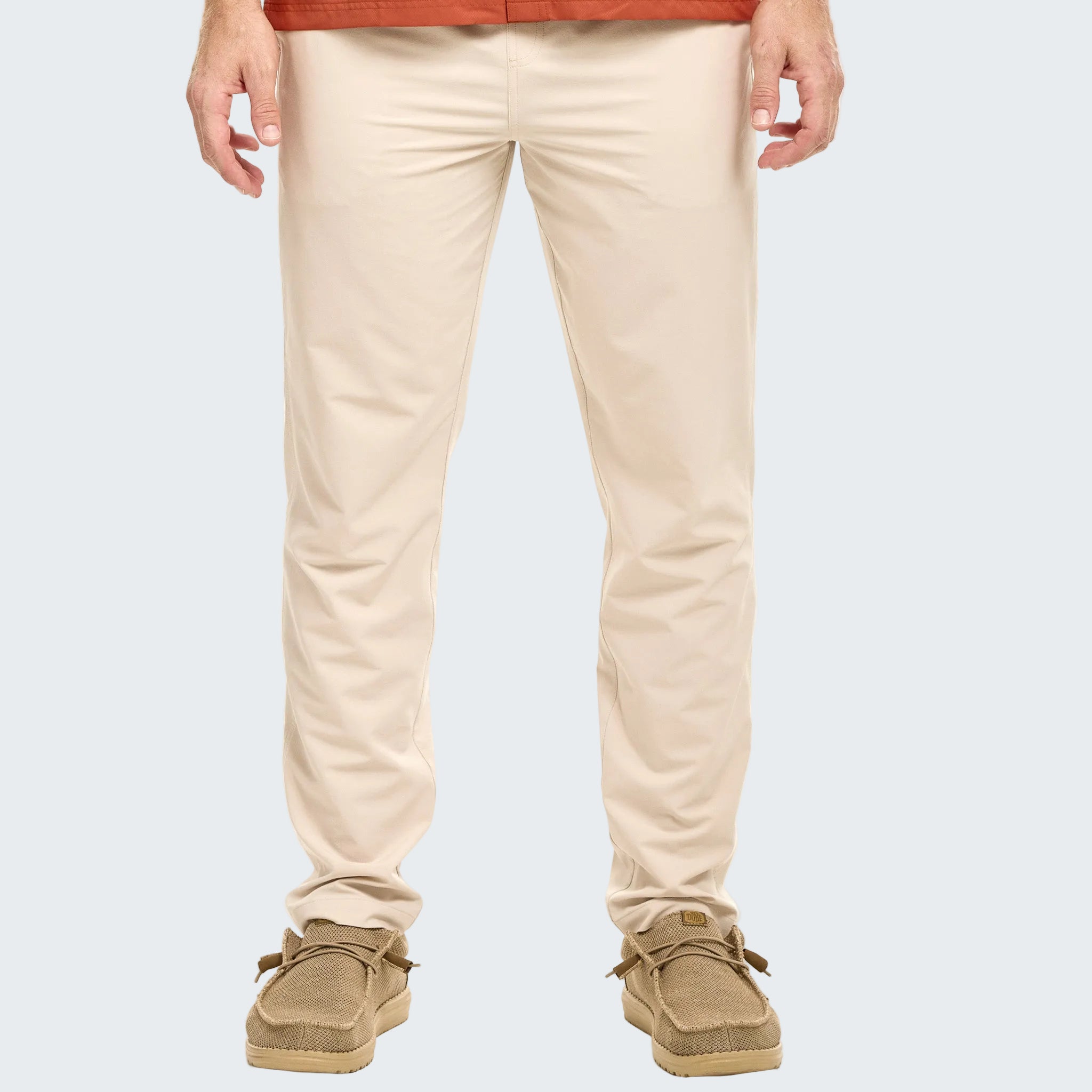Beige pants worn by a person on a white background