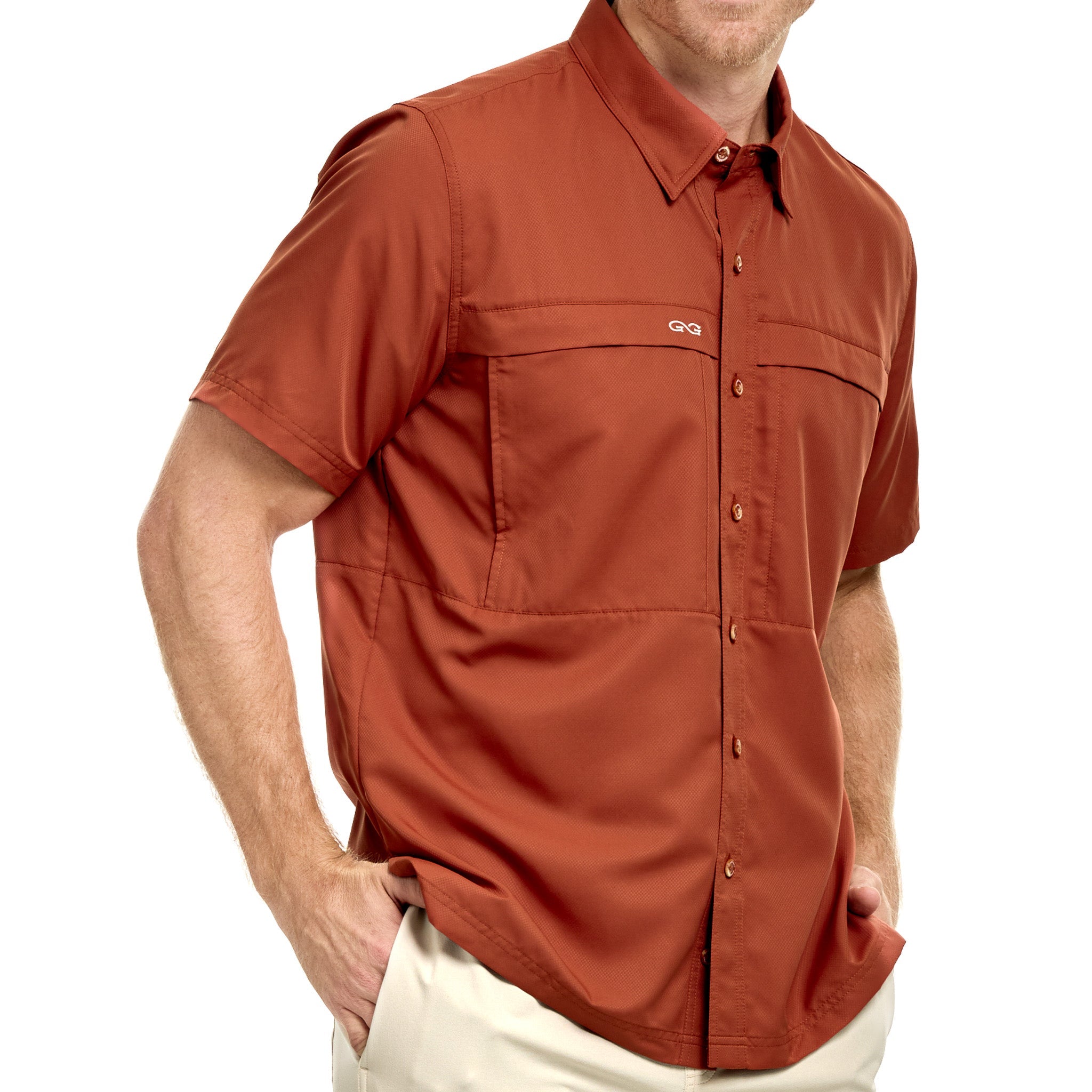Man wearing a rust-colored short-sleeve shirt on a white background