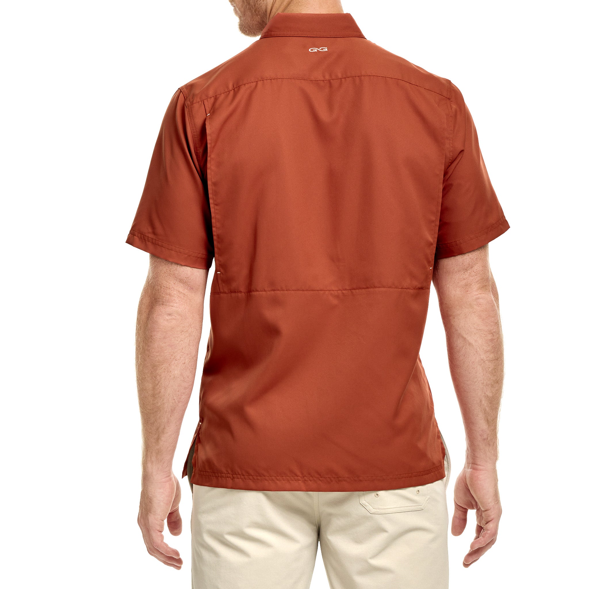 Person wearing a rust-colored short-sleeve shirt on a white background