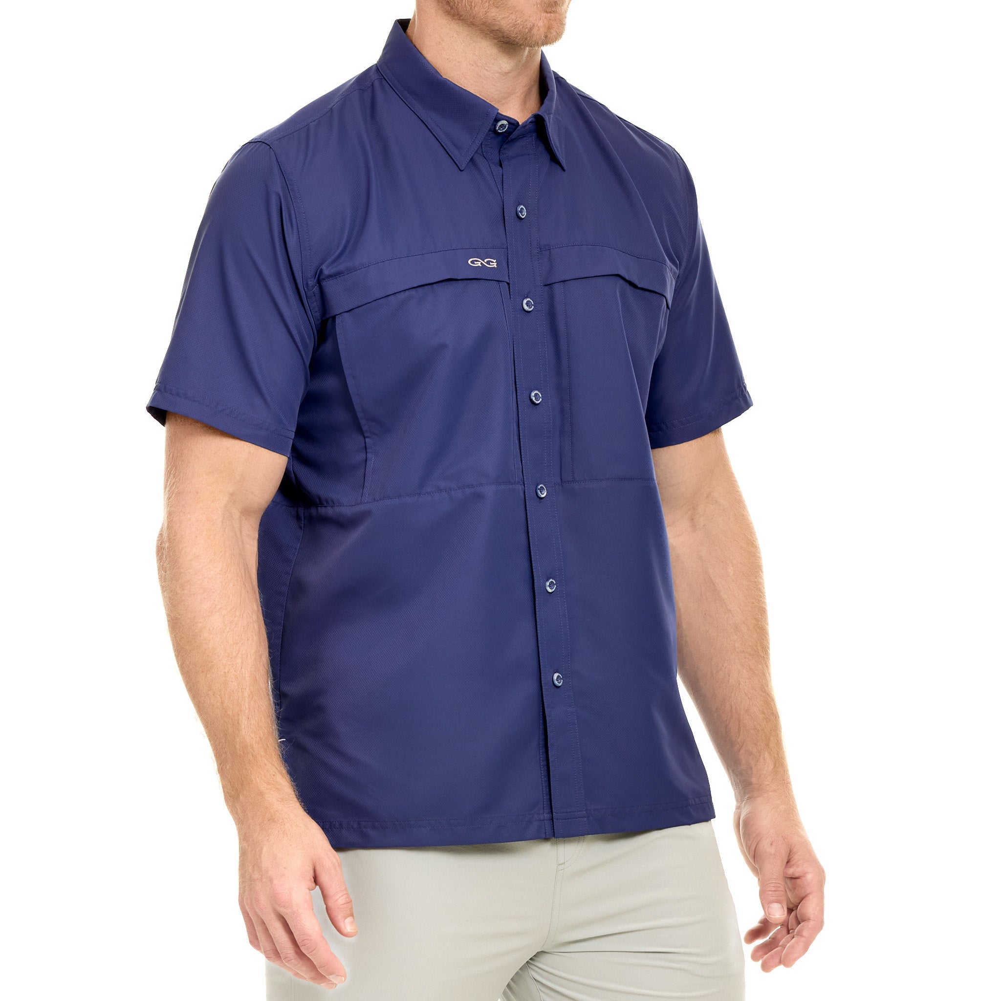 Man wearing a blue short-sleeve shirt with button details on a white background