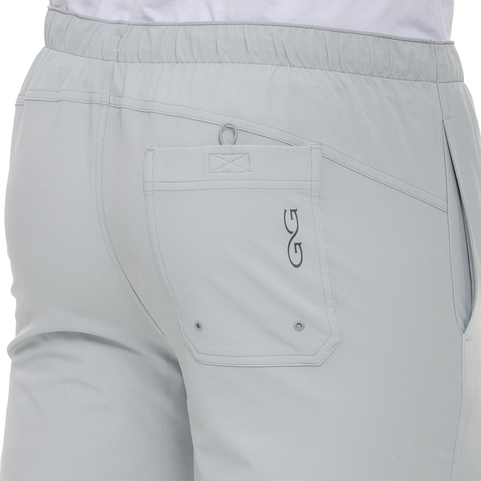 Light gray pants with a logo on the pocket against a white background