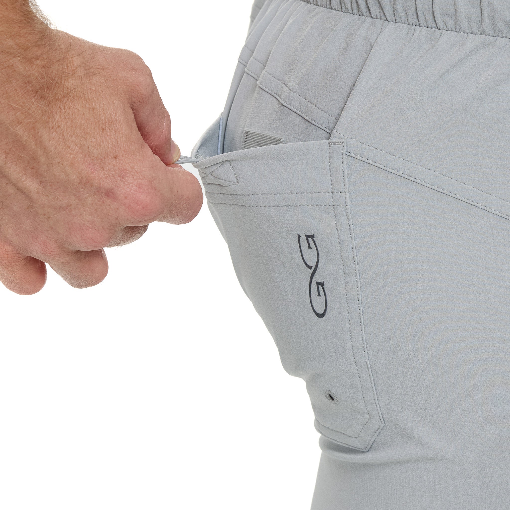Close-up of gray shorts with a brand logo on a white background