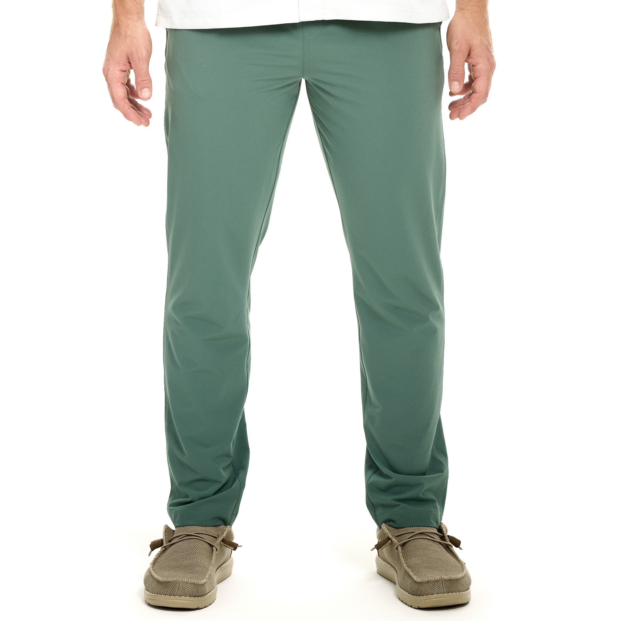 Green pants worn by a person on a white background