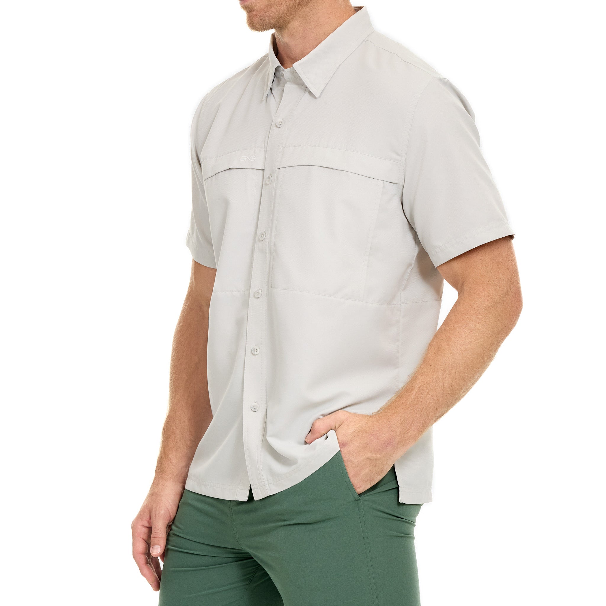 Man wearing a light gray short-sleeve shirt and green pants on a white background