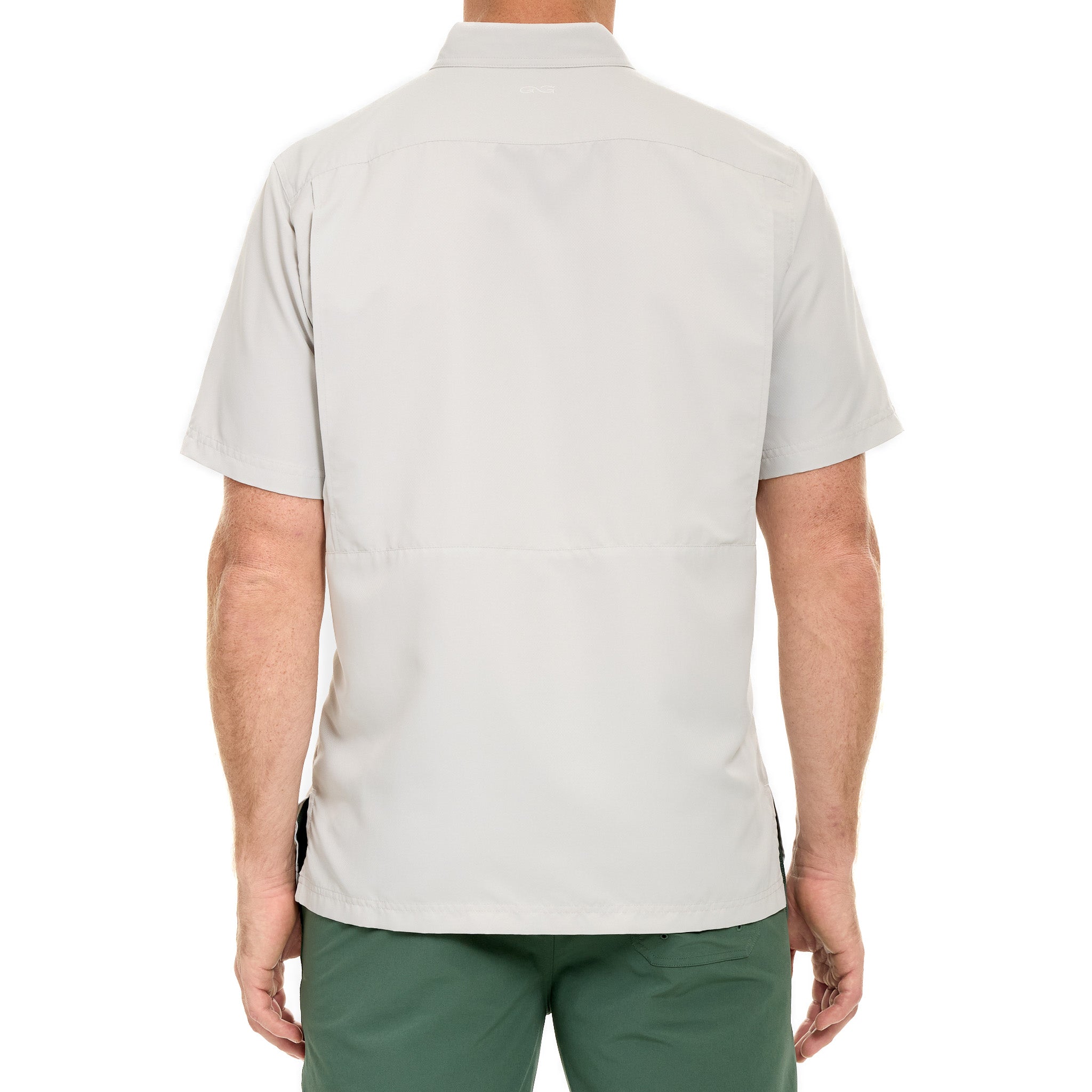 Person wearing a light gray polo shirt and green shorts on a white background