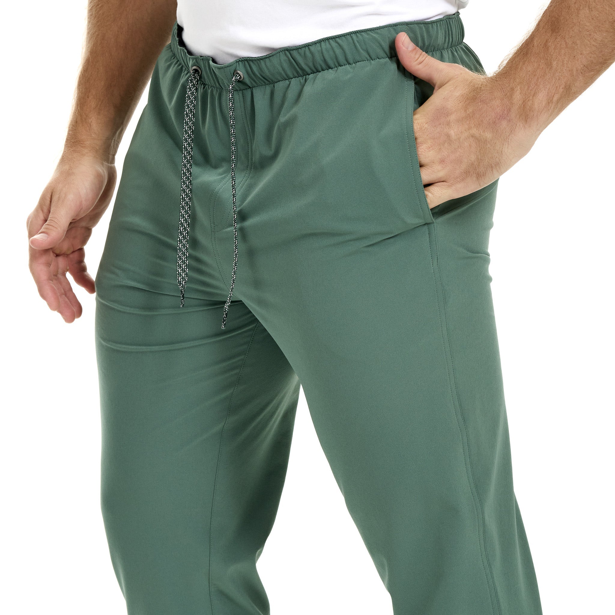 Green pants worn by a person on a white background