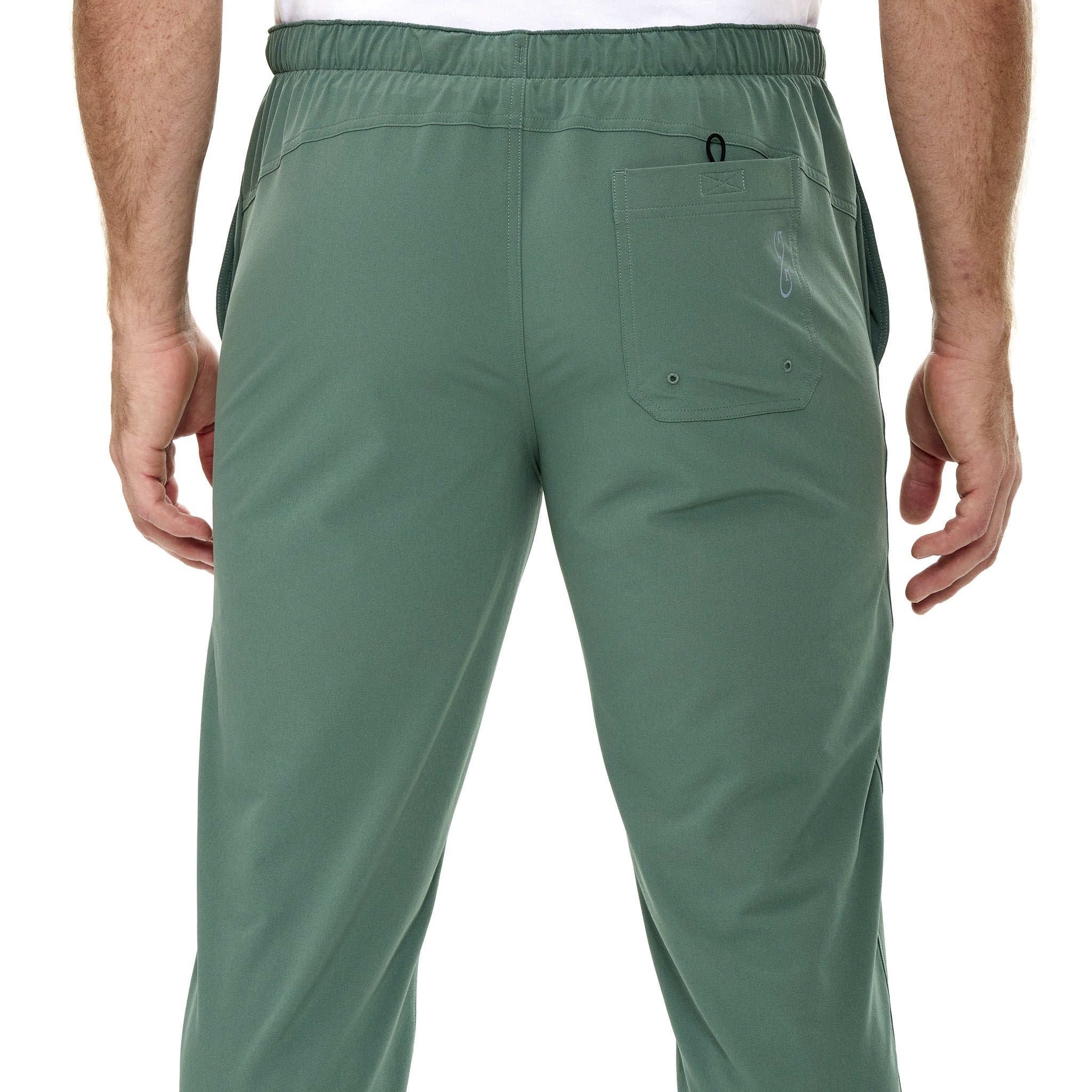 Green pants worn by a person on a white background