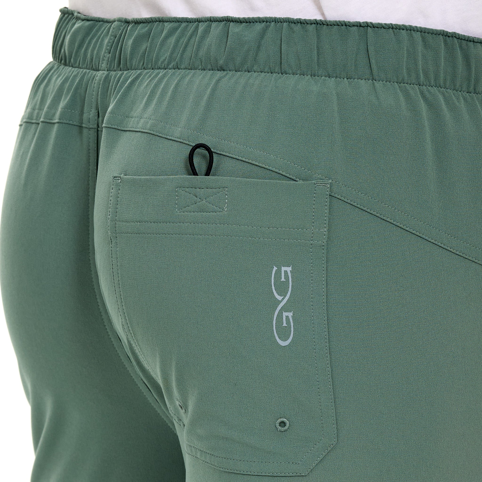 Green pants with a logo on the pocket against a white background