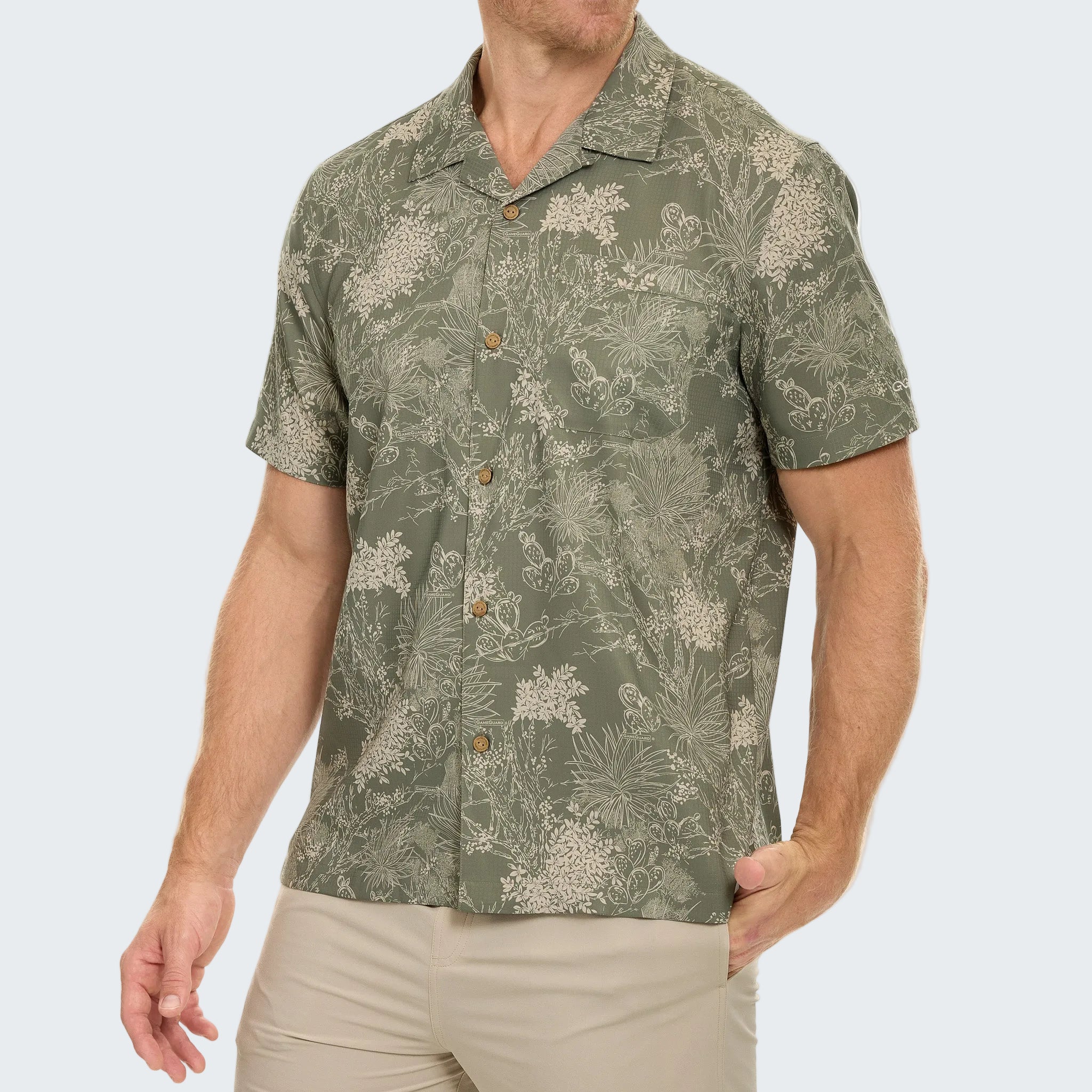 Man wearing a green floral patterned shirt on a white background