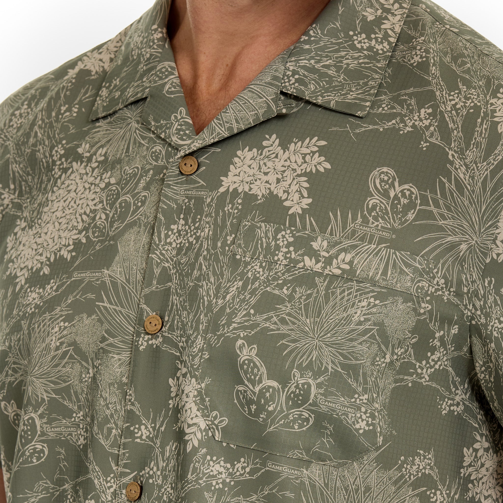 Green floral patterned shirt with buttons on a white background