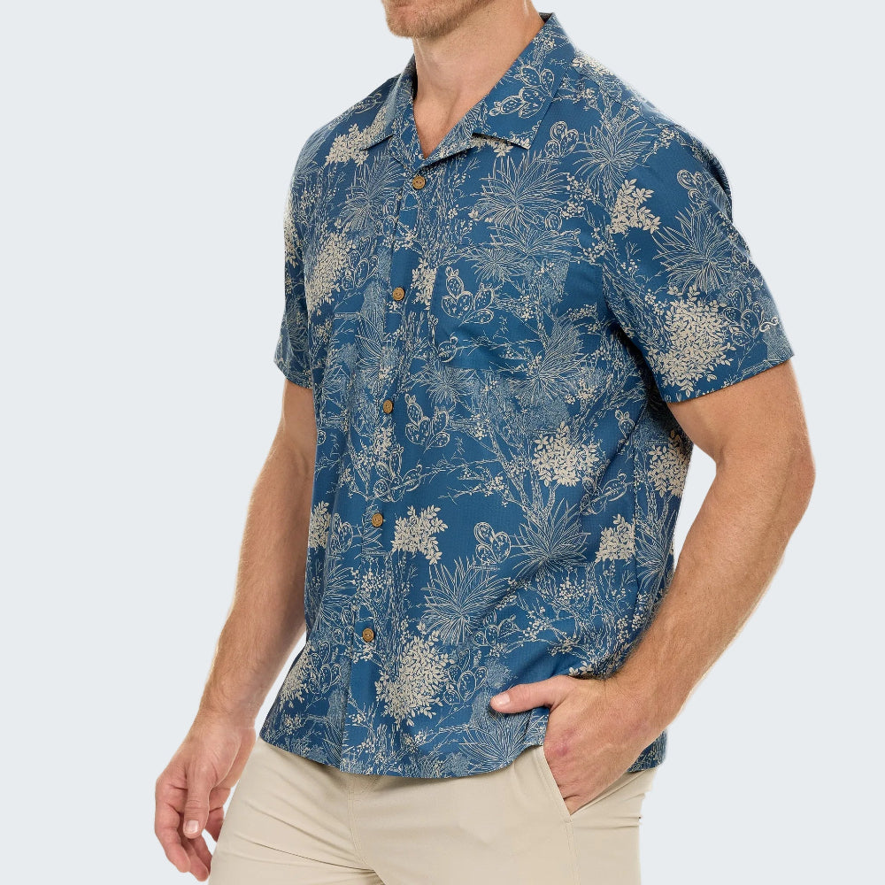 Man wearing a blue floral patterned shirt on a white background