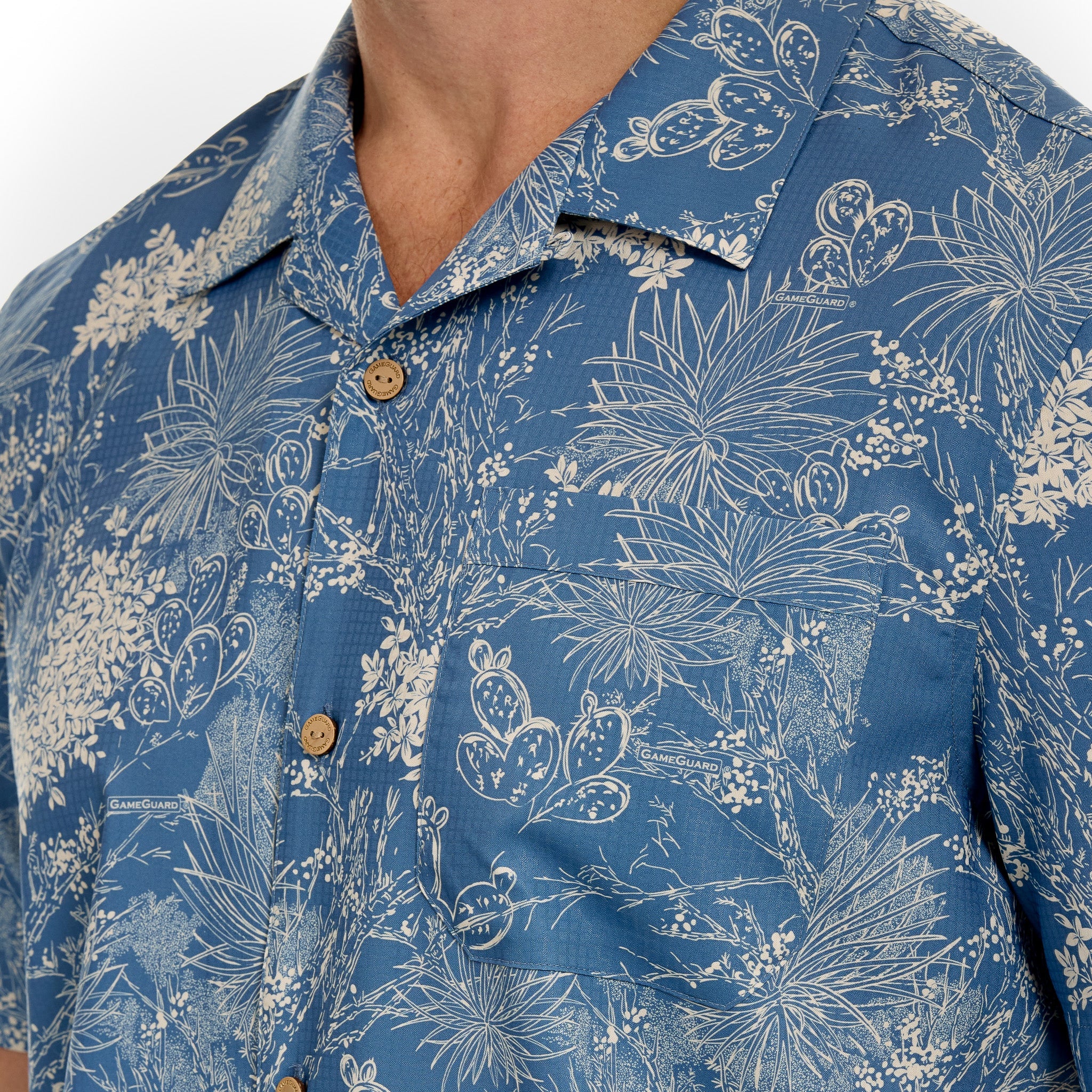 Close-up of a blue floral patterned shirt with a person wearing it.