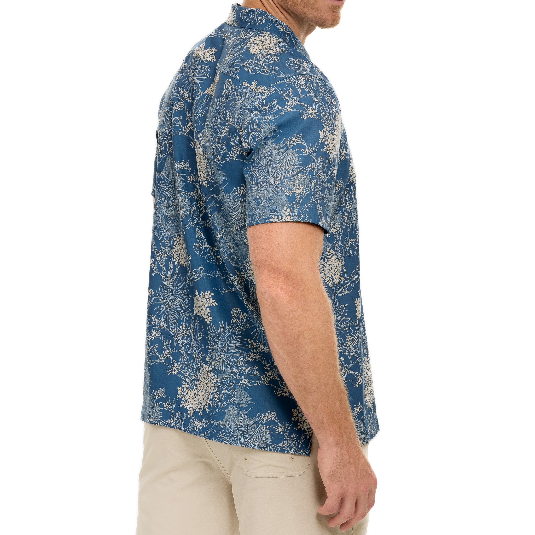 Man wearing a blue floral patterned shirt on a white background