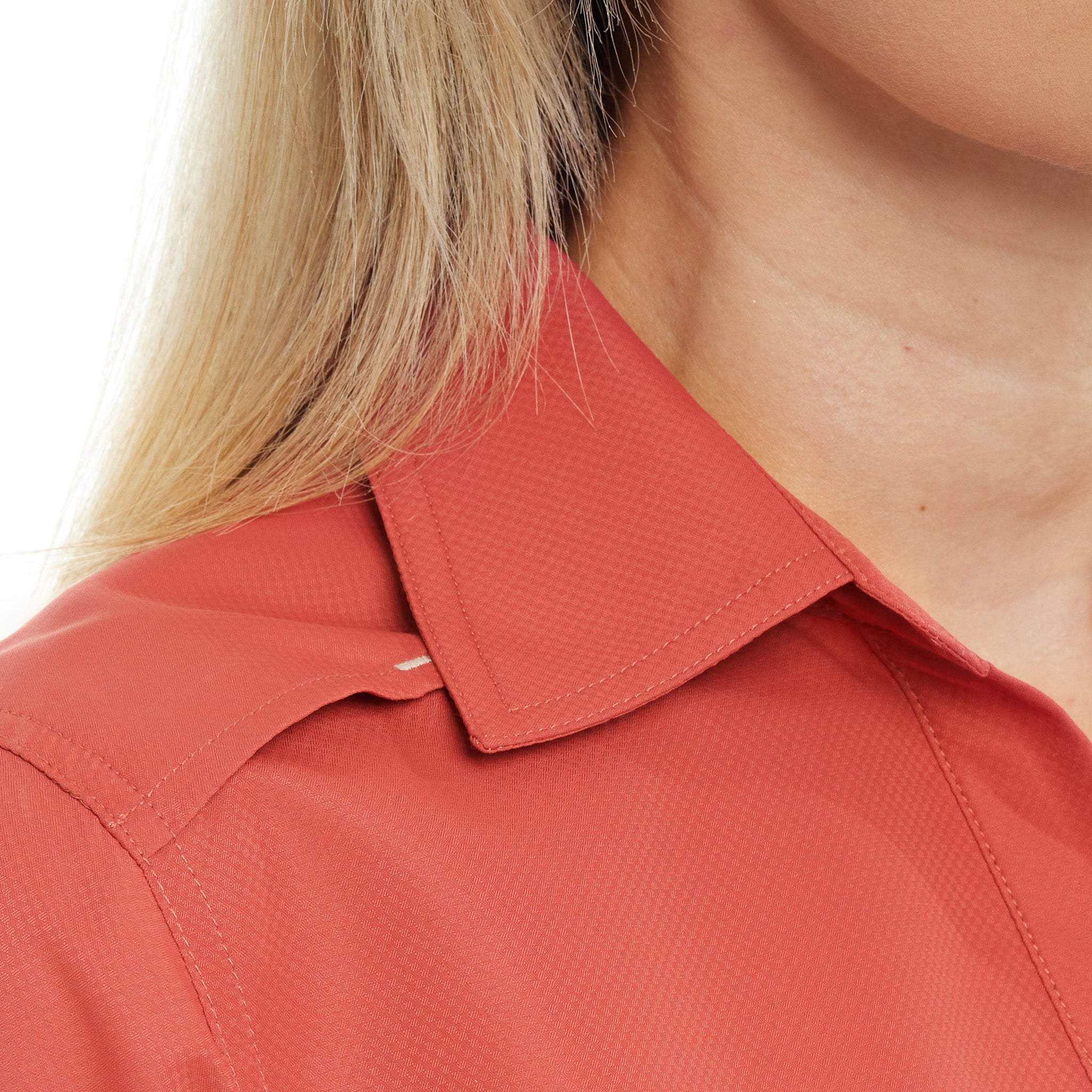Close-up of a person wearing a red shirt with a collar on a white background
