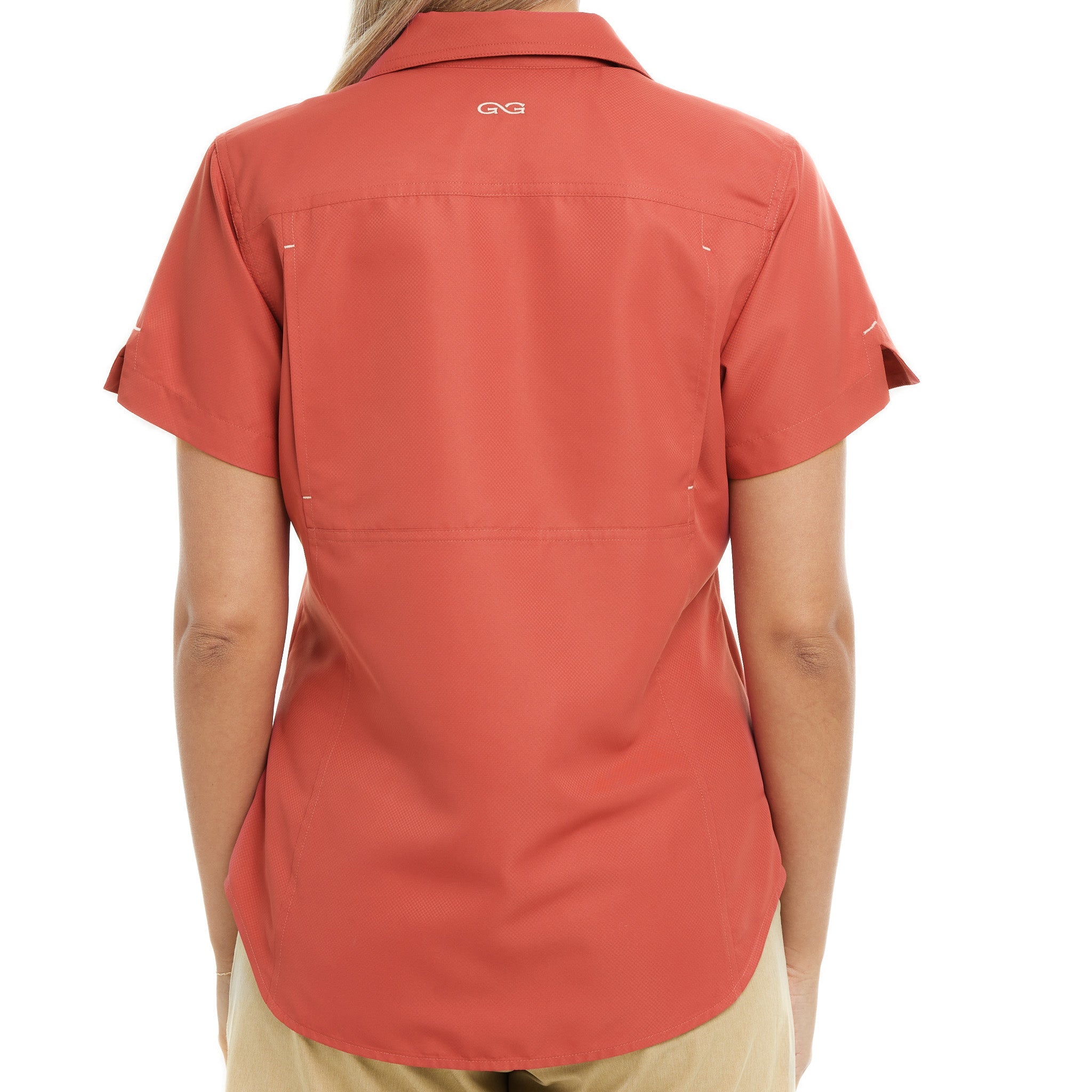 Person wearing a red shirt with a brand logo on the back, on a white background