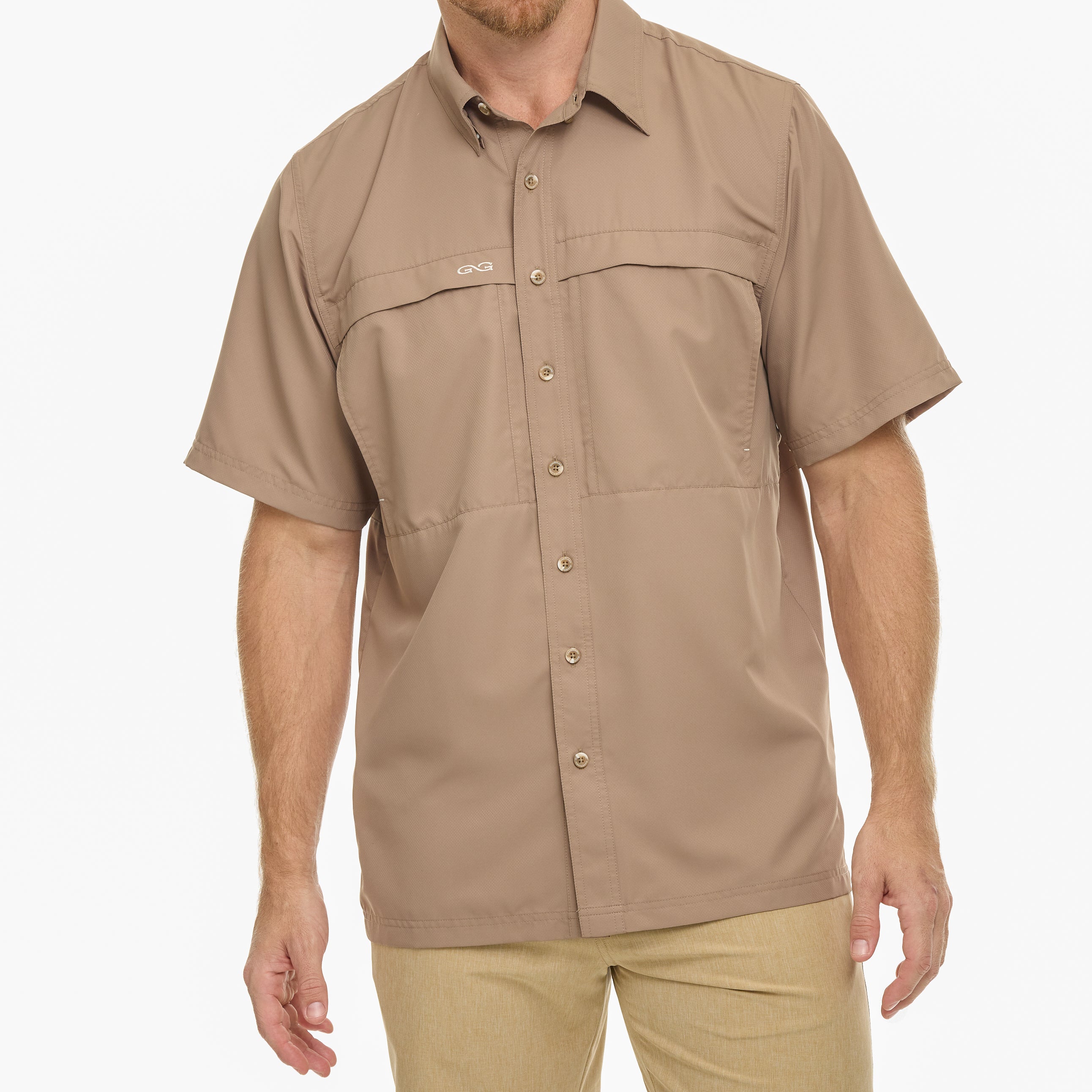 Man wearing a beige short-sleeve shirt on a white background