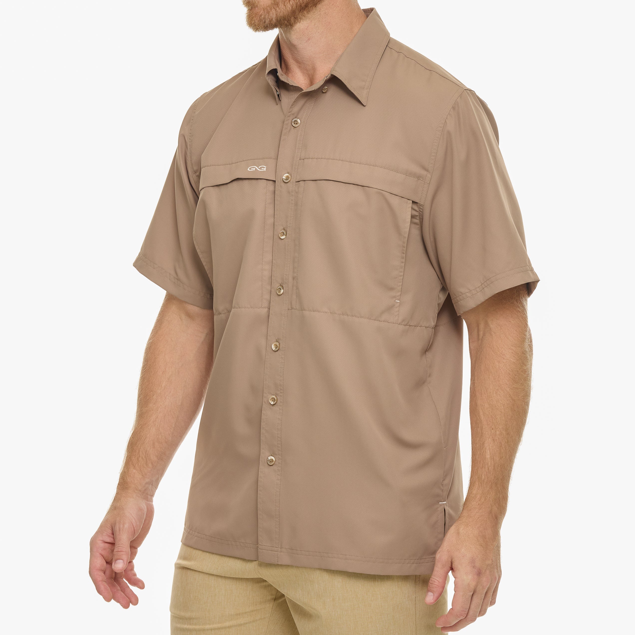 Man wearing a beige short-sleeve shirt on a white background