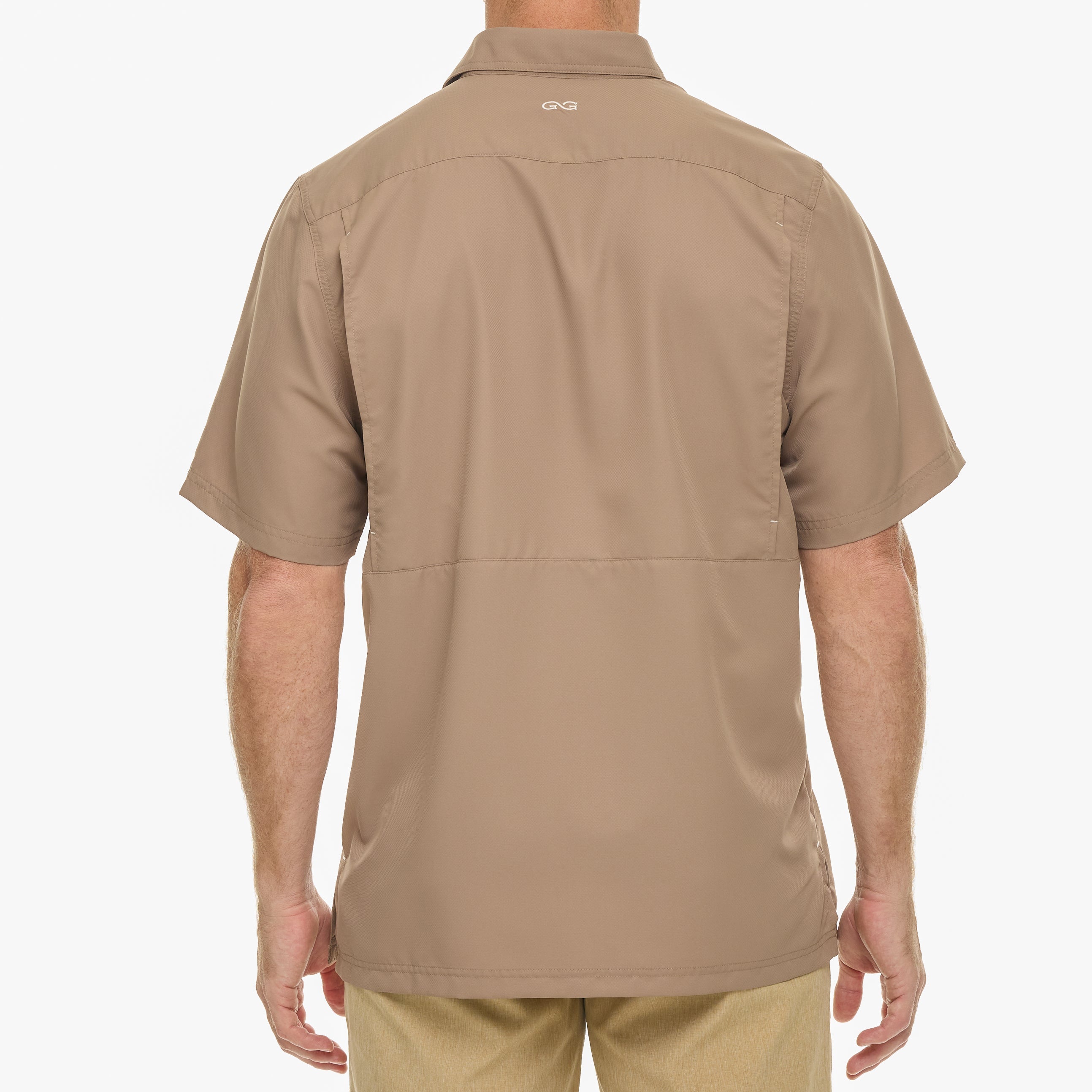 Beige short-sleeve shirt worn by a person on a white background