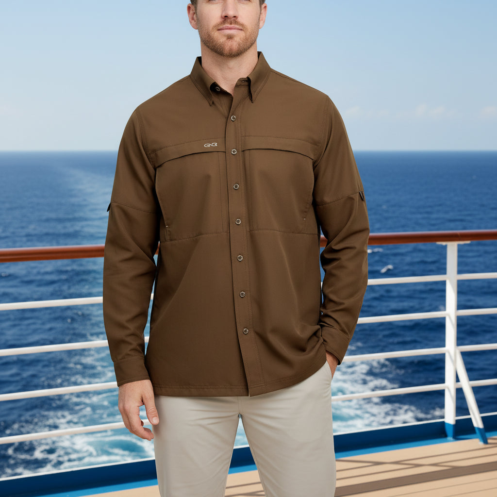 A man wearing a brown long-sleeve button-up shirt with a collar, button front, and two chest pockets, paired with light gray pants, shown against a plain white background.