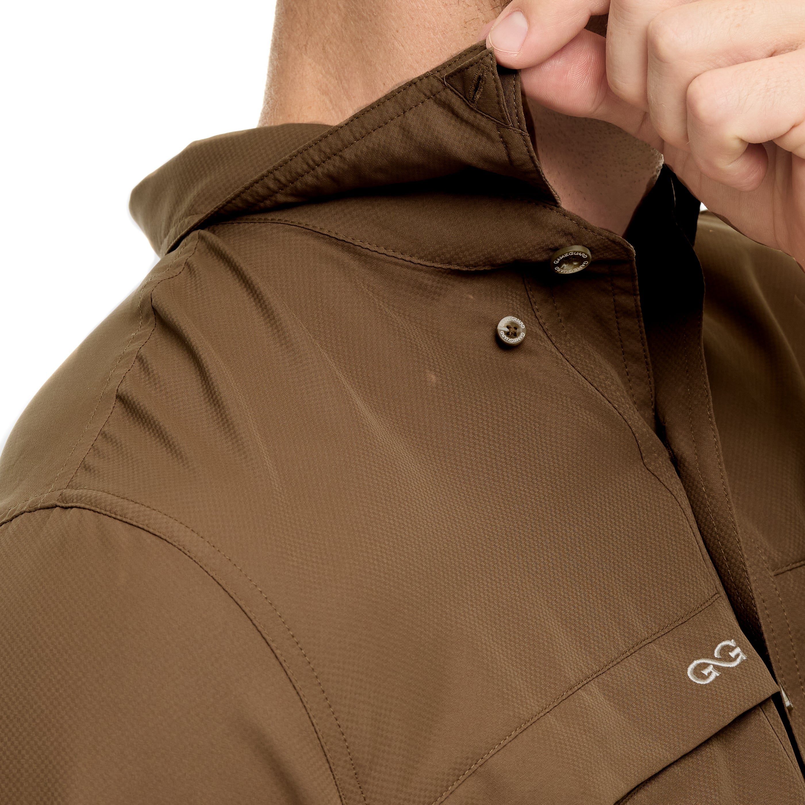Close-up of a brown jacket with a brand logo on a white background