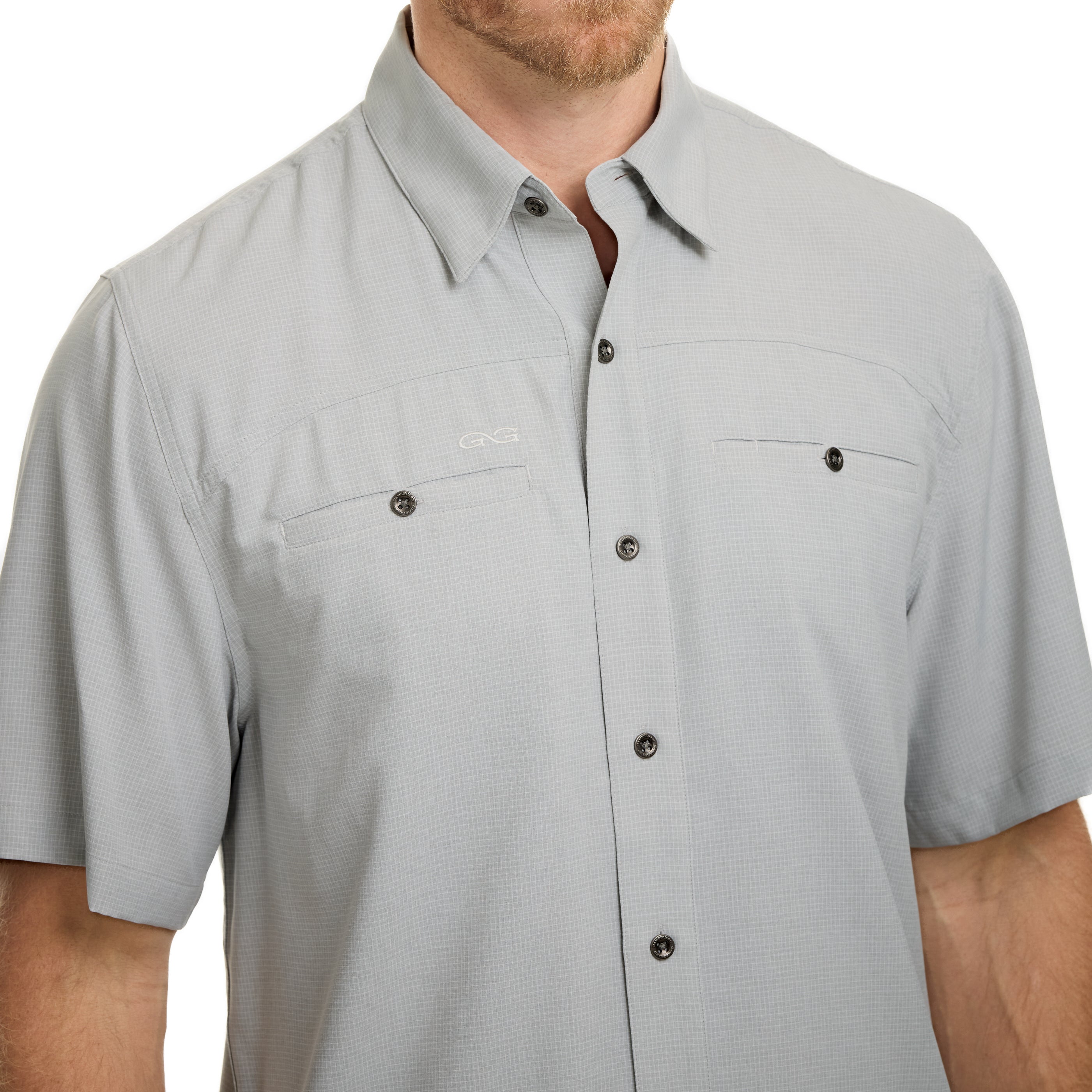 Gray short-sleeve button-up shirt worn by a person on a white background