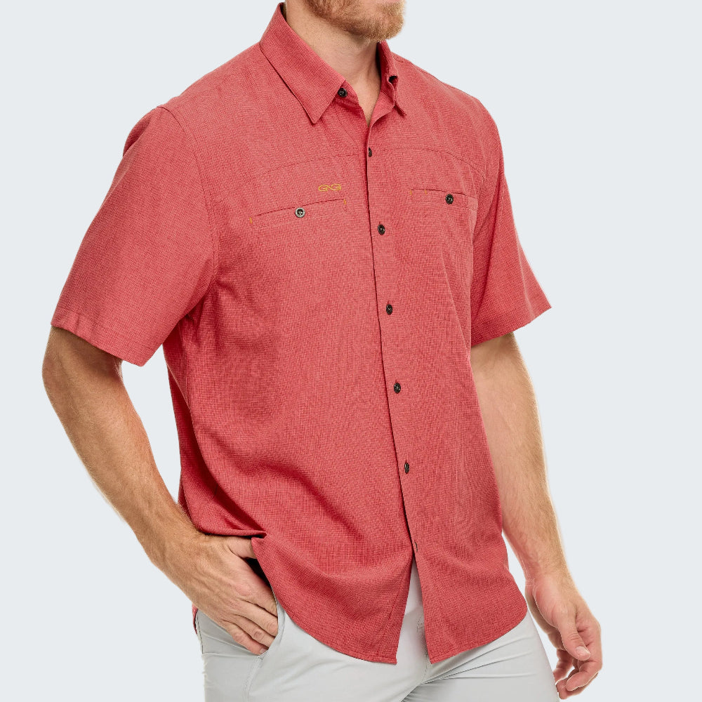 Man wearing a red short-sleeve shirt with a brand logo on a white background