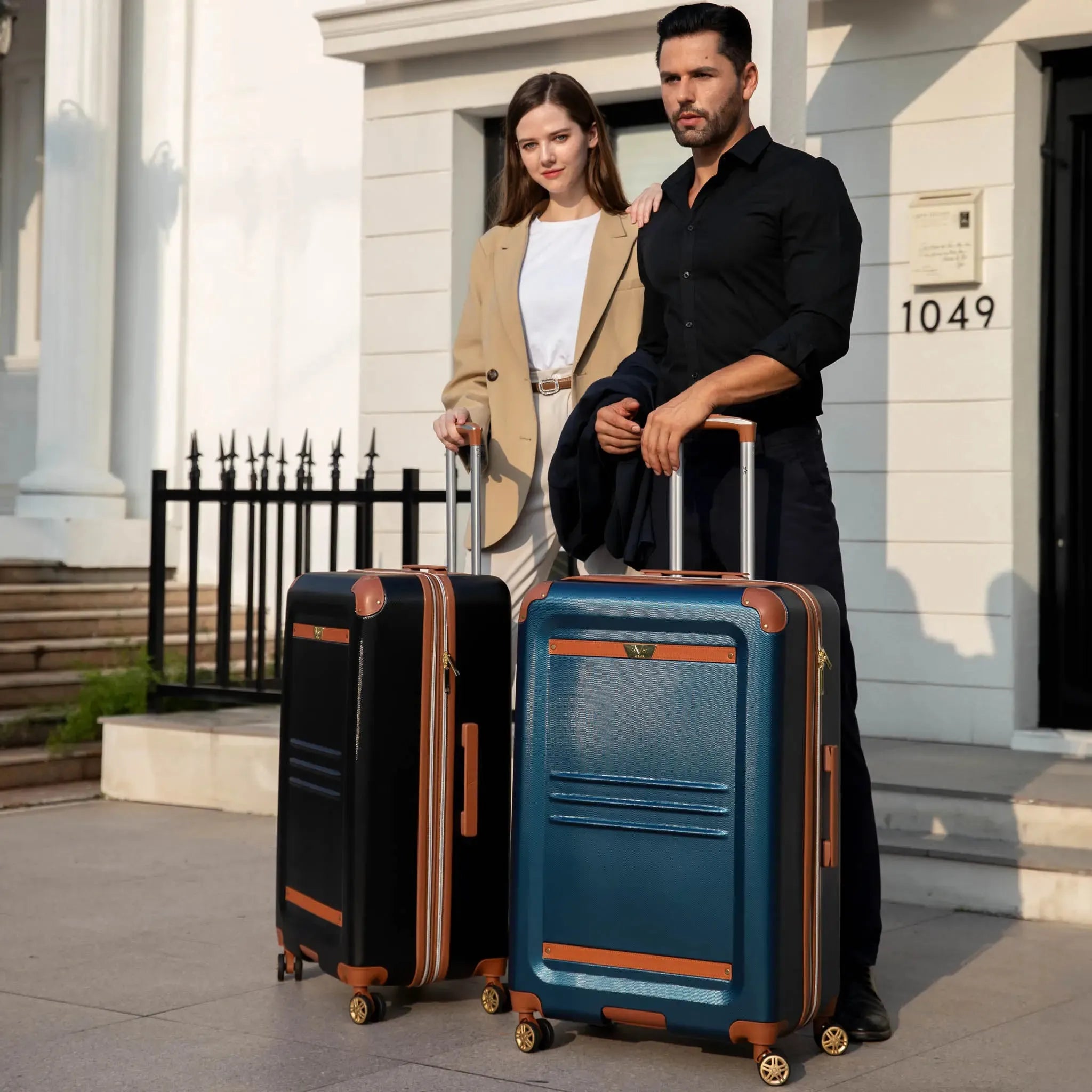 Man and woman with suitcases standing outside a building