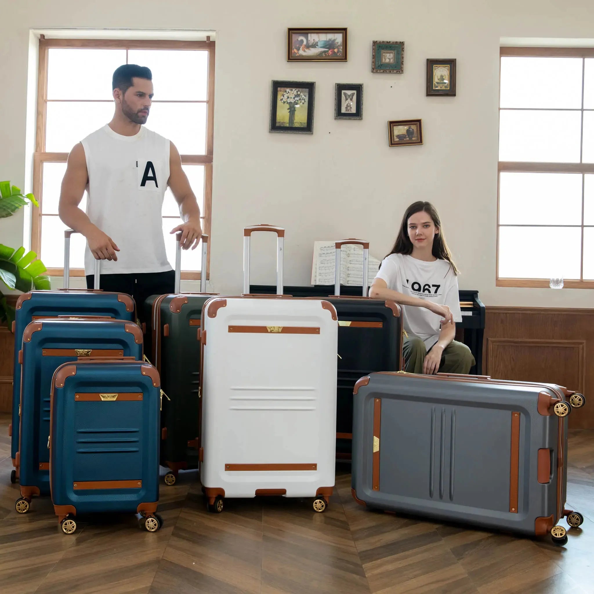 Two people standing in a room with multiple suitcases of different colors and designs.