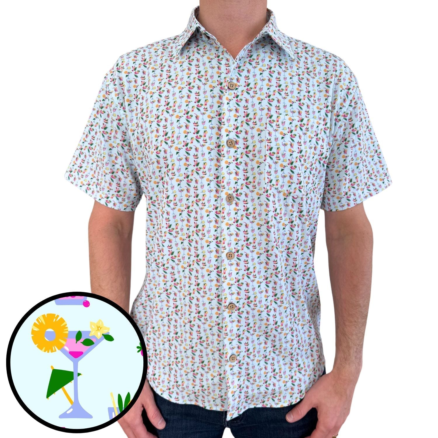 Person wearing a short-sleeve button-up shirt with a colorful pattern on a white background