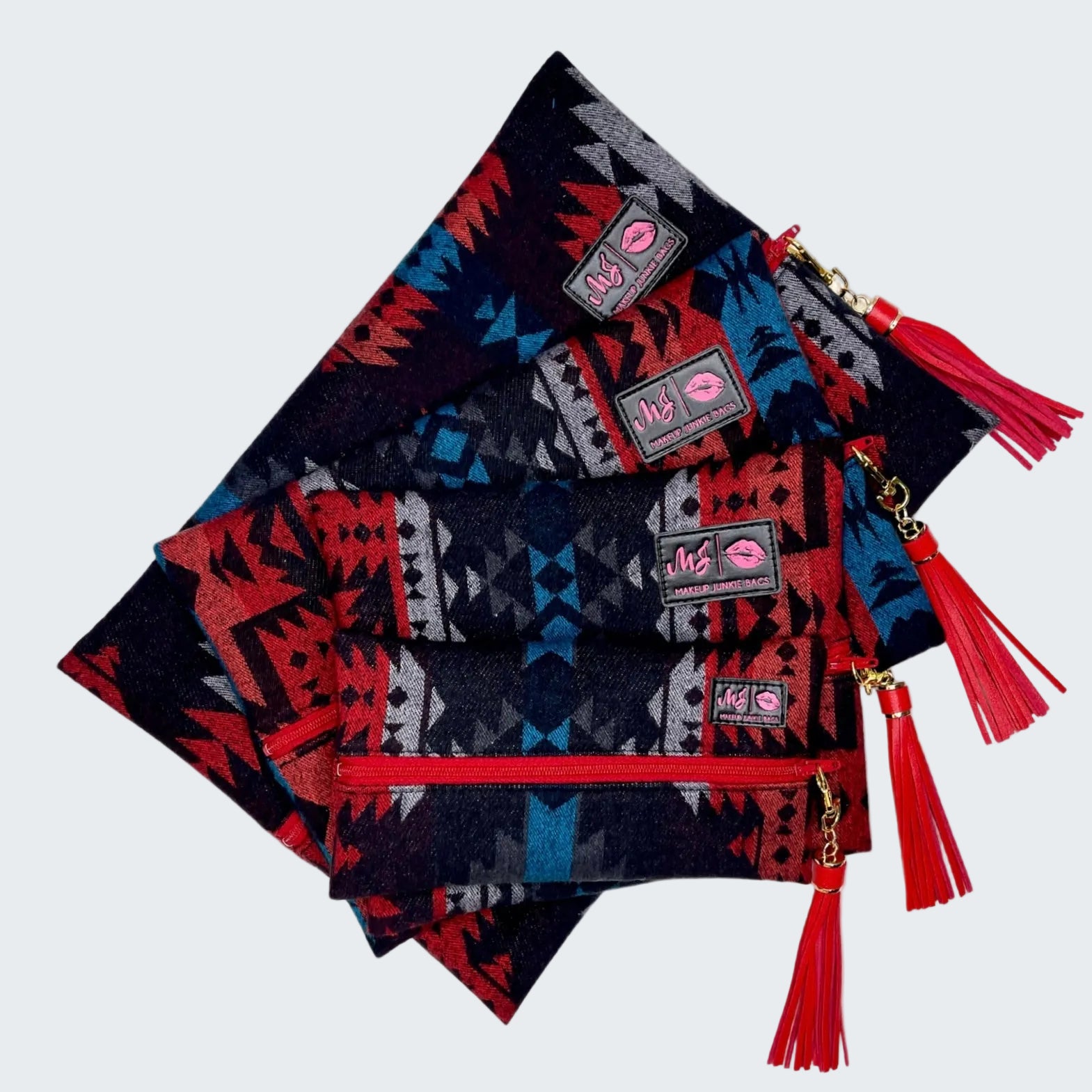 Two patterned pouches with red tassels on a white background
