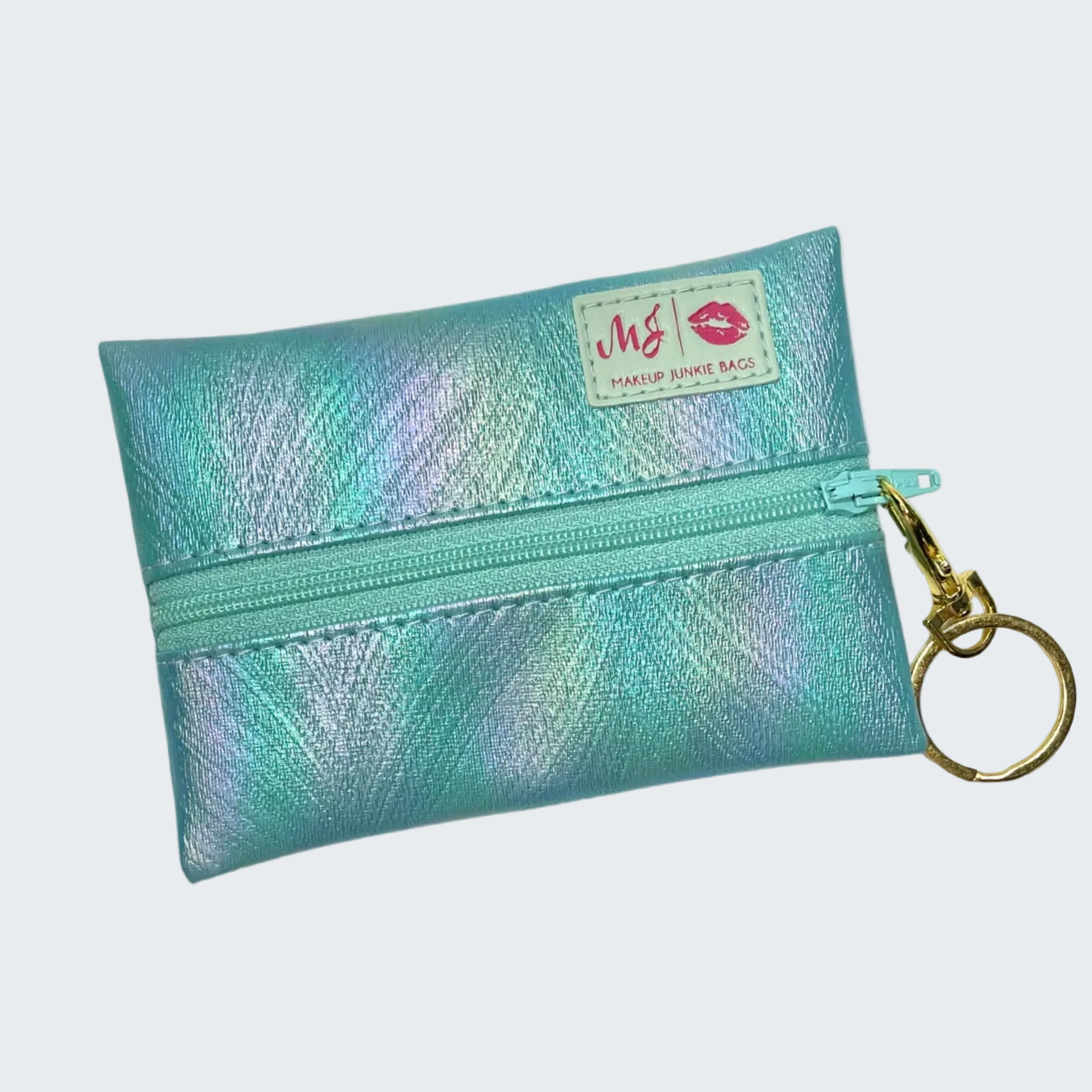 Turquoise pouch with gold zipper and keychain on a white background
