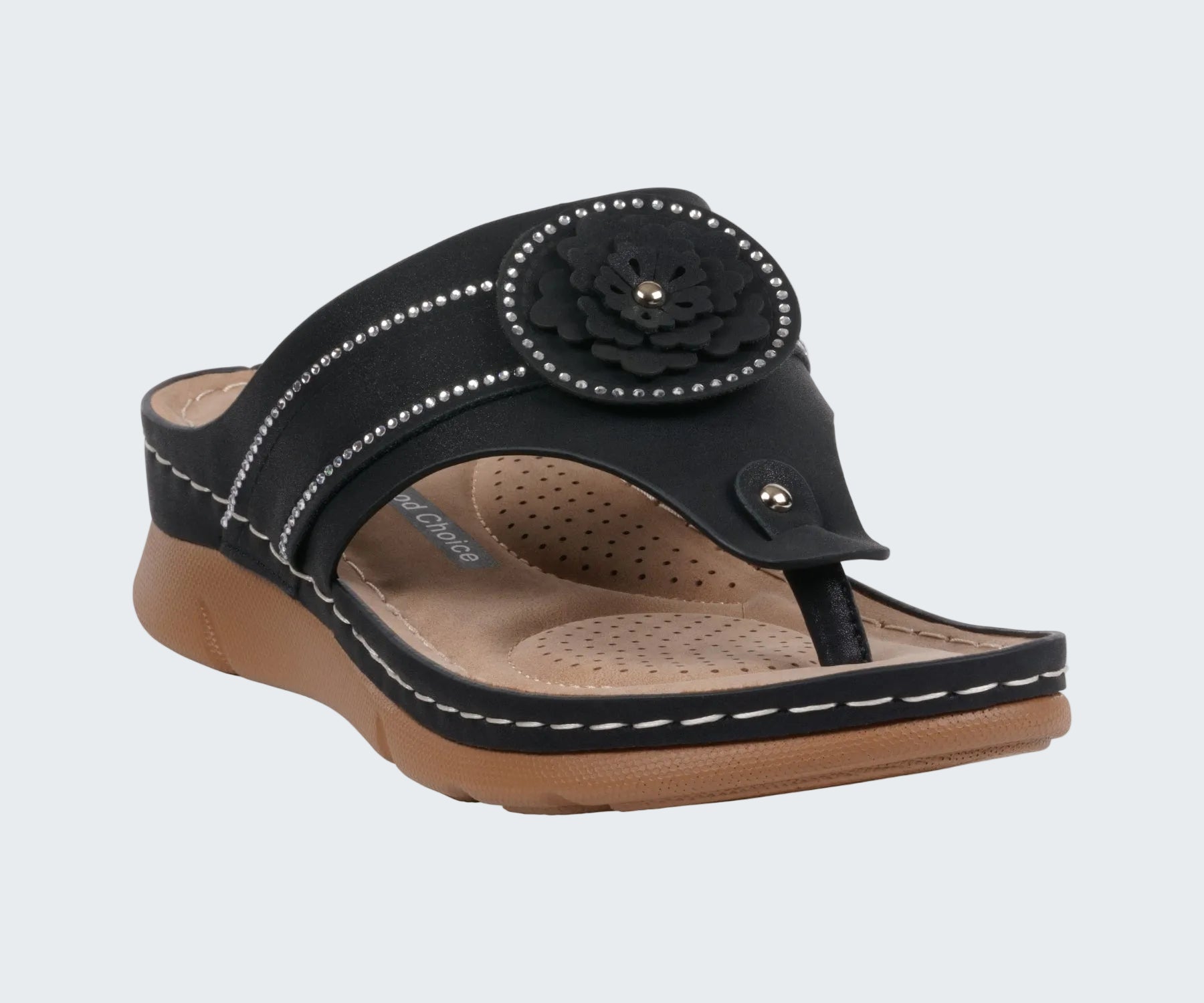 Black sandal with a flower design on a white background
