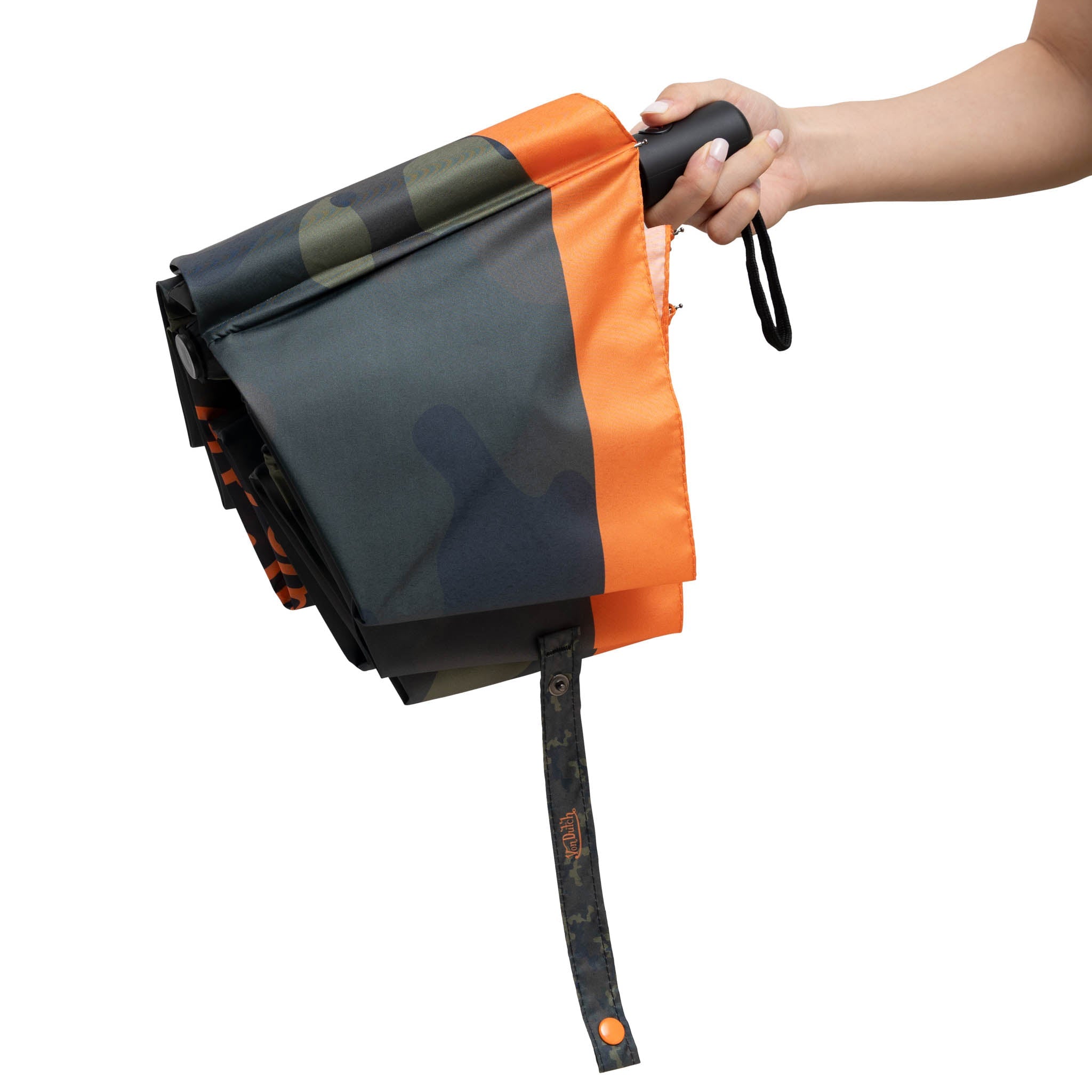 Folded umbrella with camouflage pattern held by a hand on a white background