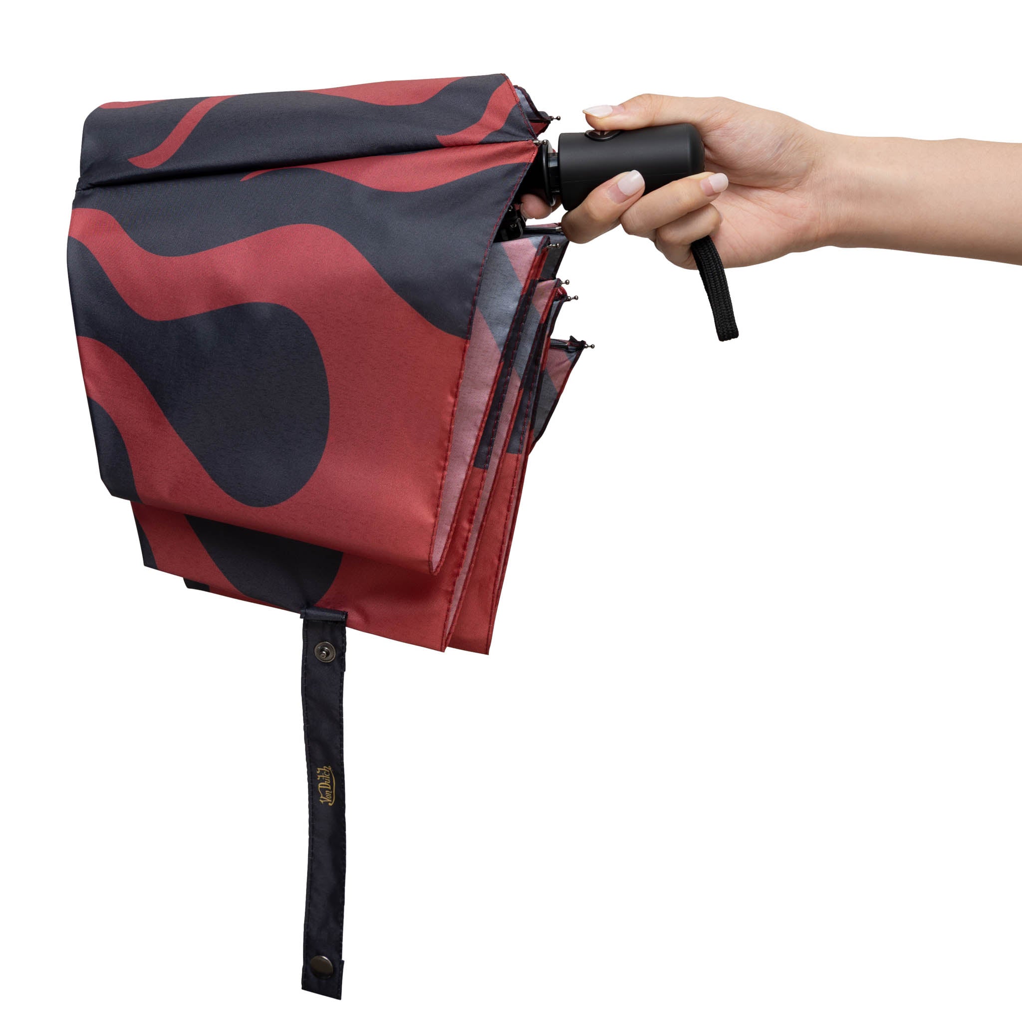 Red and black patterned umbrella being held open by a hand on a white background