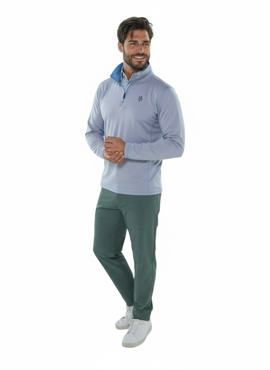 Man wearing a light blue pullover and green pants on a white background