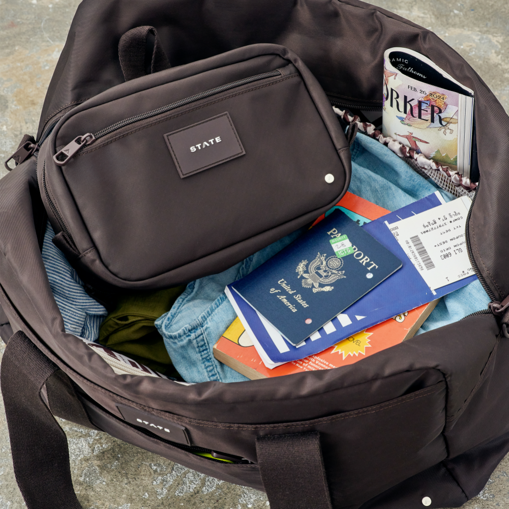 Open suitcase with travel documents and a passport inside
