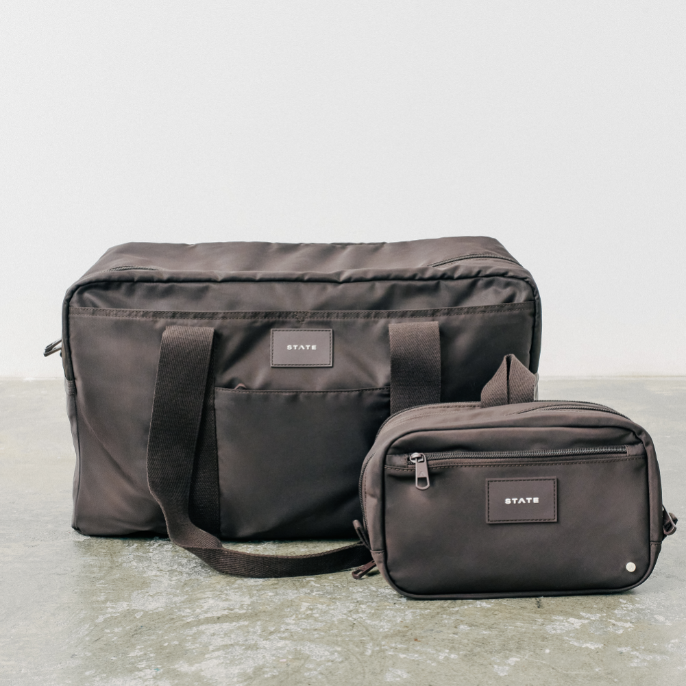 Two black bags with 'STATE' label on a light gray background