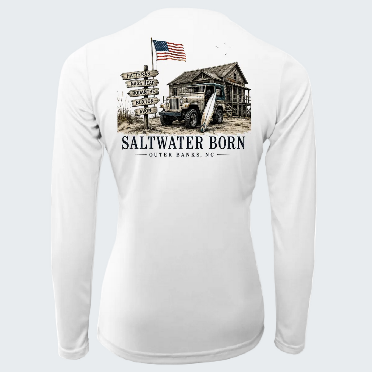 White long-sleeve performance shirt shown from the back, featuring a large graphic print of a rustic cabin, vintage truck, surfboard, wooden signpost with destinations, and the text 'SALTWATER BORN - OUTER BANKS, NC'.