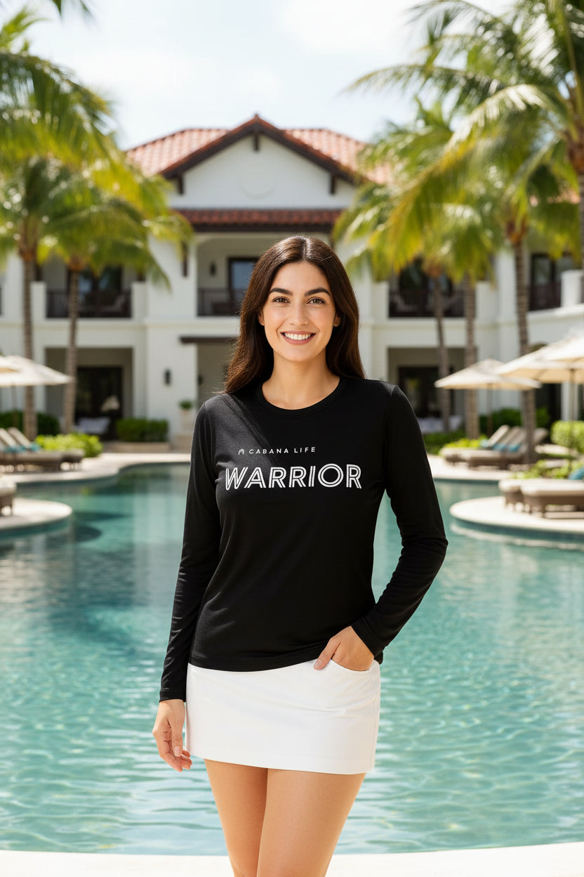 Woman wearing a black long-sleeve shirt with 'Cabaña Life Warrior' text on a light gray background