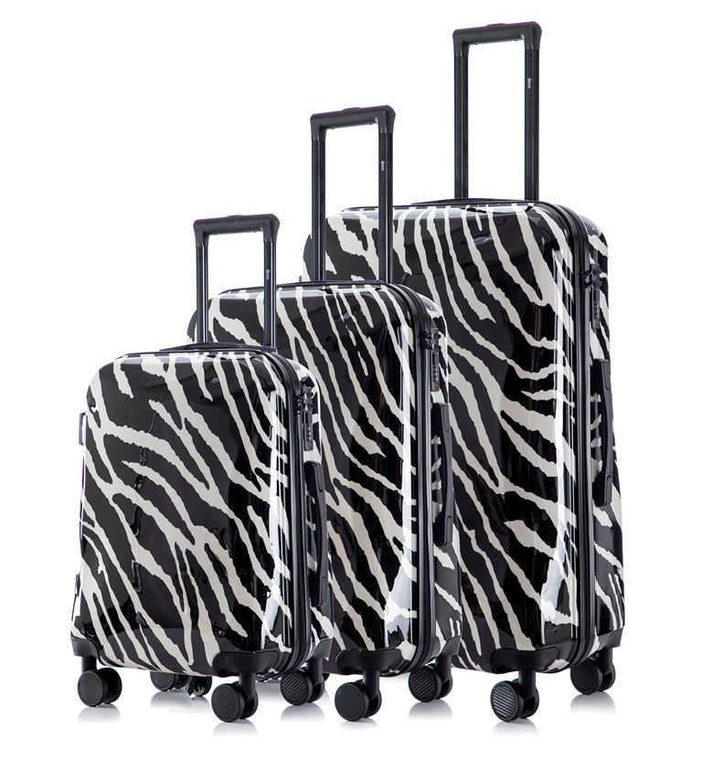 Set of three zebra-patterned suitcases on a white background