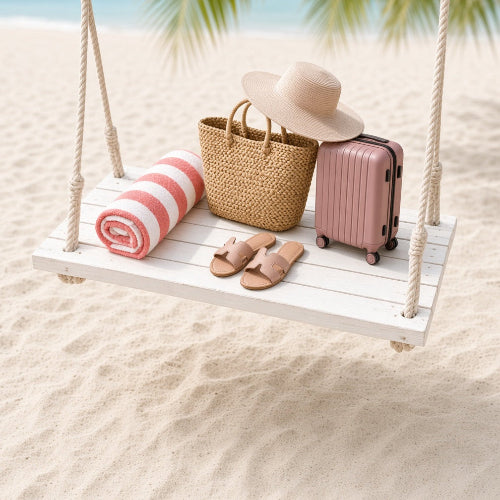 A beach-themed scene with a white wooden swing hanging over sand, holding a straw hat, woven tote bag, pink suitcase, and a striped towel. A real beach environment with sand, ocean, and palm leaves is visible in the background.