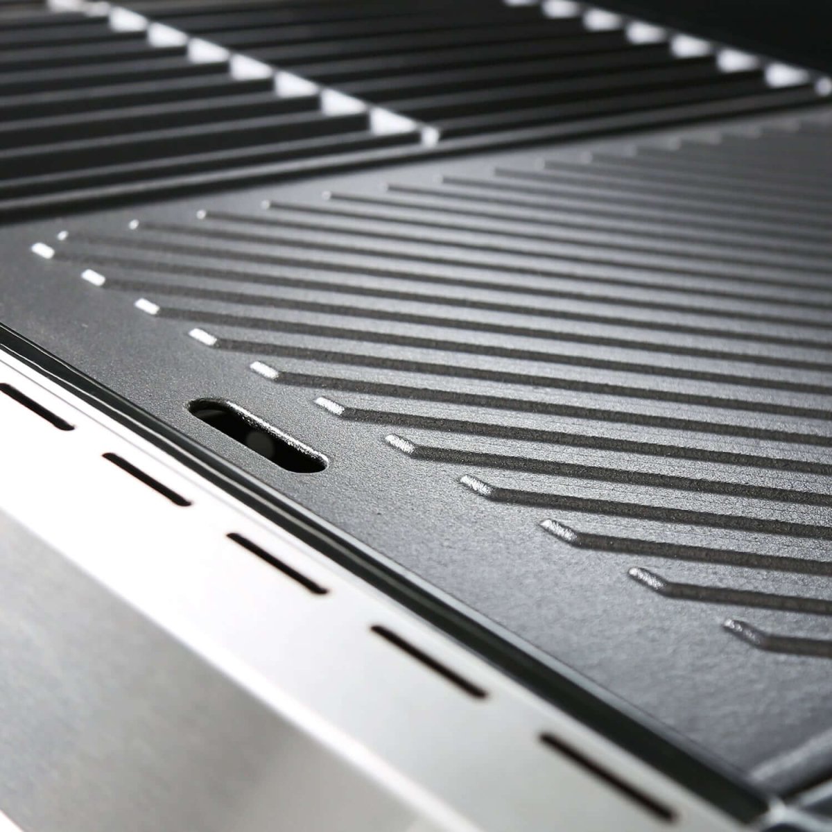 Close-up of a metal grill grate with a textured surface