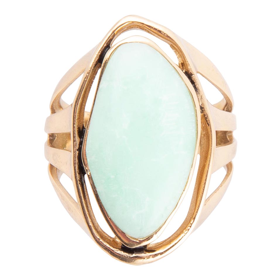 Gold ring with a light green stone on a white background